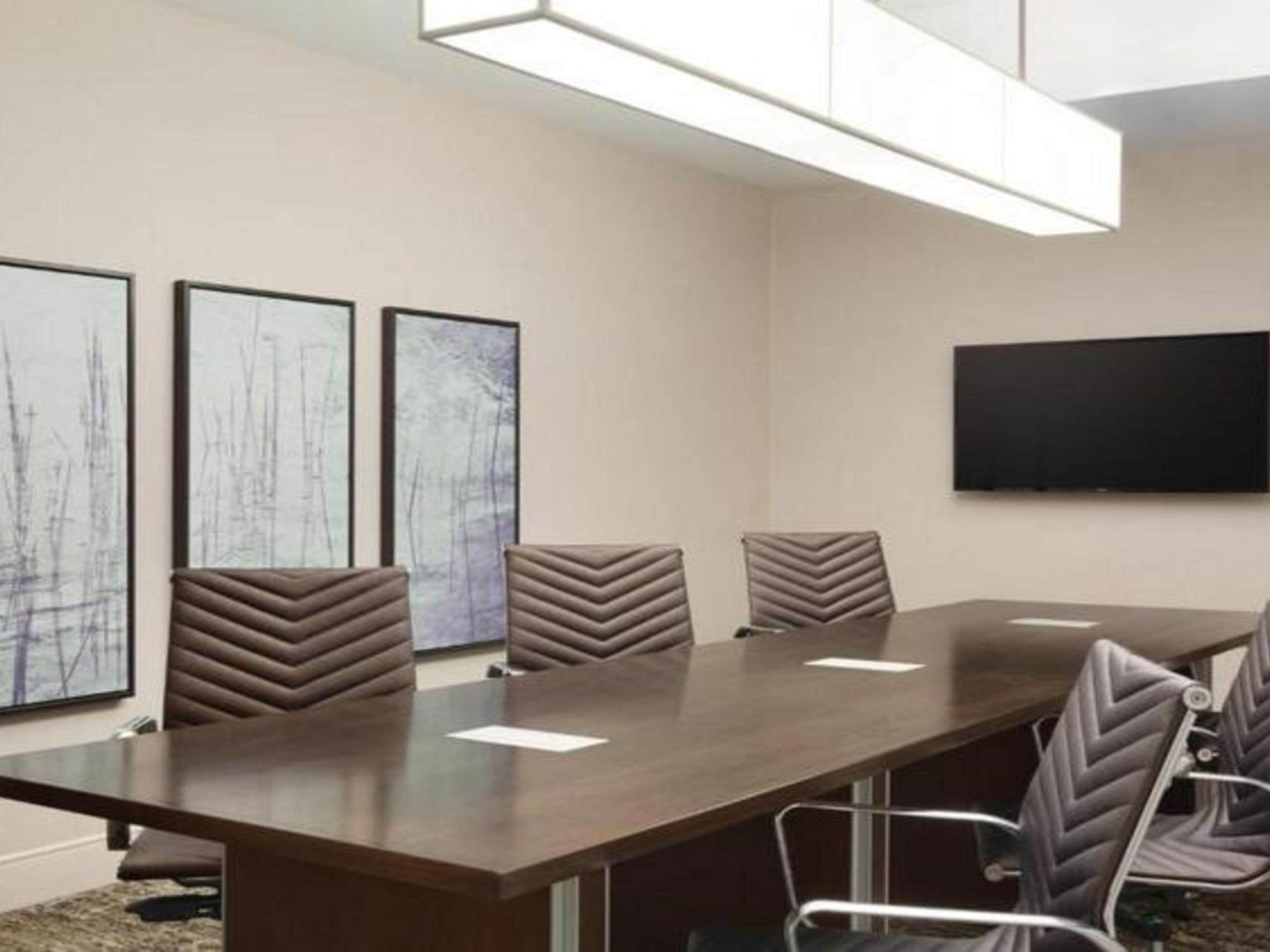 Our conference room offers a comfortable setting for up to 10 guests, ideal for business meetings and intimate gatherings. The space features a spacious boardroom table with ergonomic chairs,  with a screen, a 50-inch television, and a flip chart with an easel to support all your presentation needs.