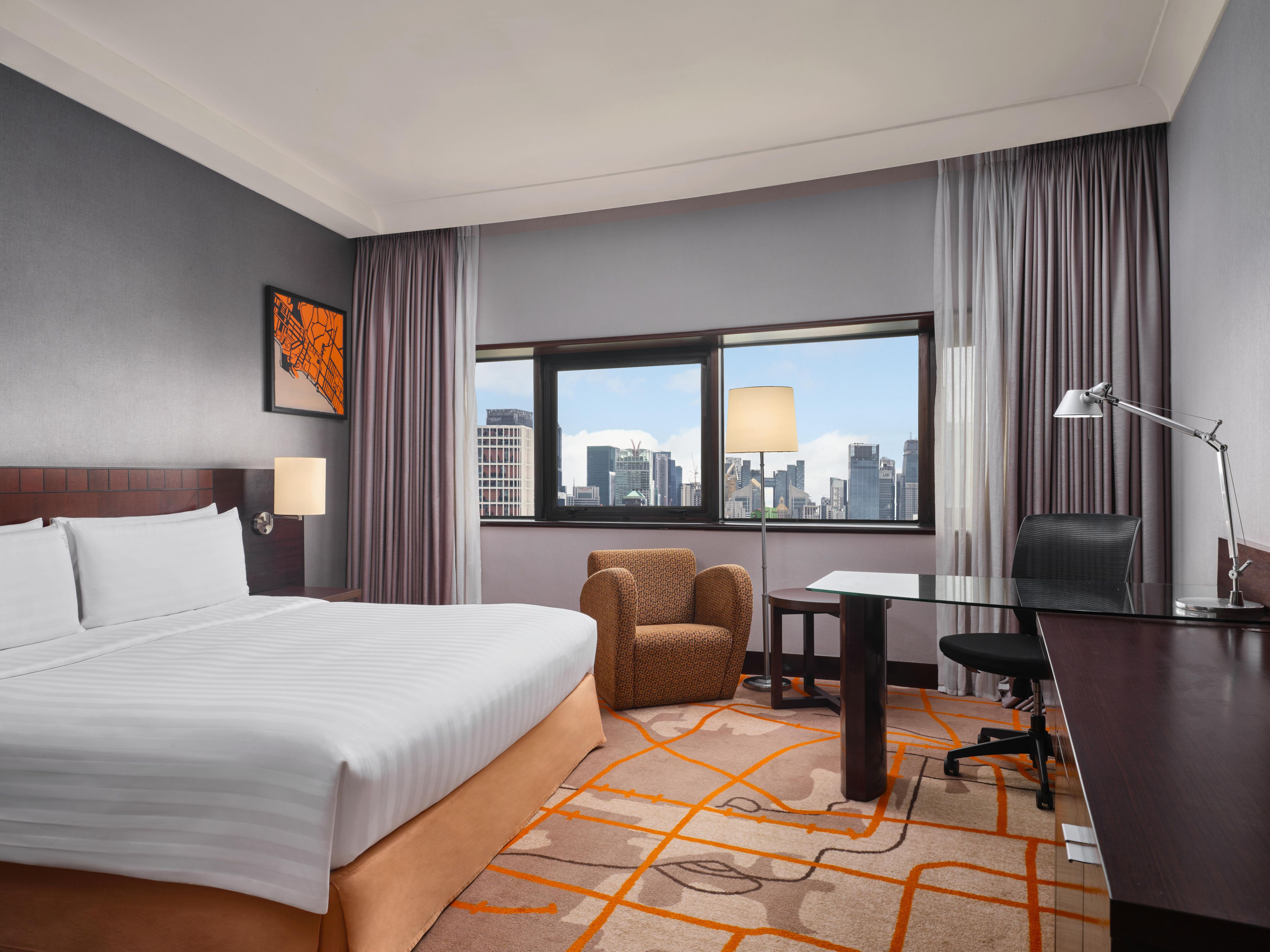 King bed with a city view of Singapore