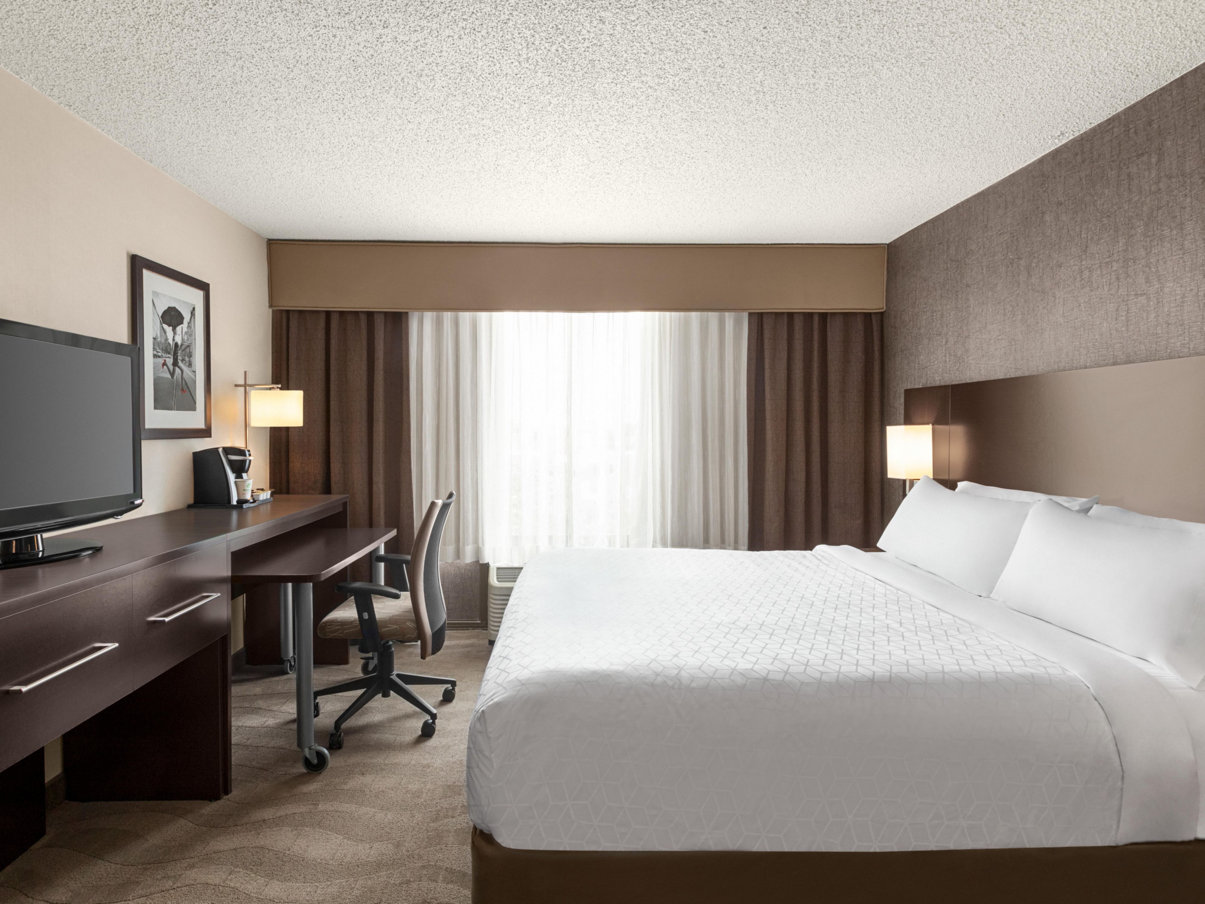 Relax in bed and catch a movie on the flat-screen TV.