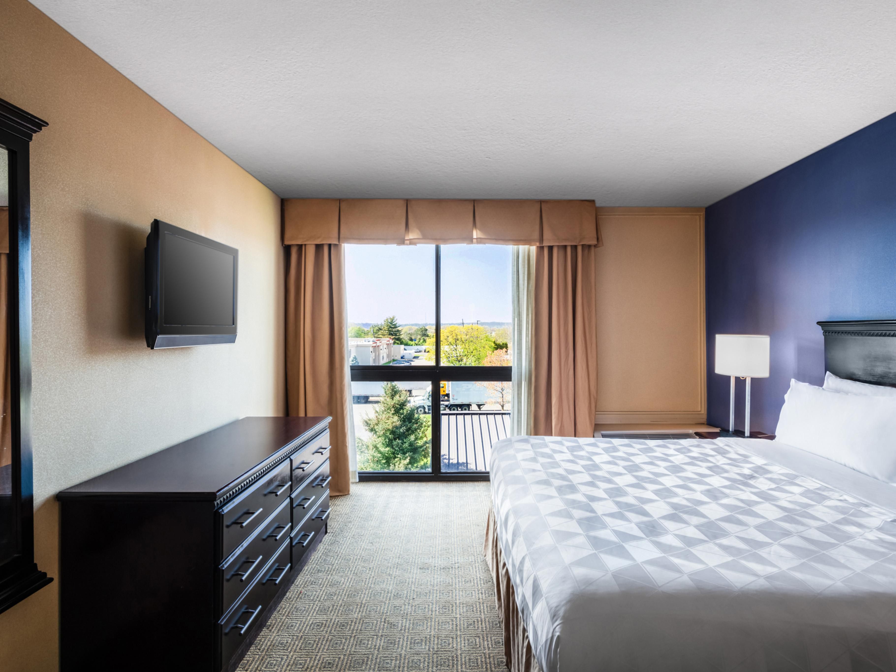 Relax and recharge in updated guest rooms featuring 55-inch TVs, free Wi-Fi, and spacious work areas. Thoughtful touches like a microwave, mini-fridge, coffeemaker, hairdryer, and ironing board add convenience, while daily housekeeping keeps your space fresh. 