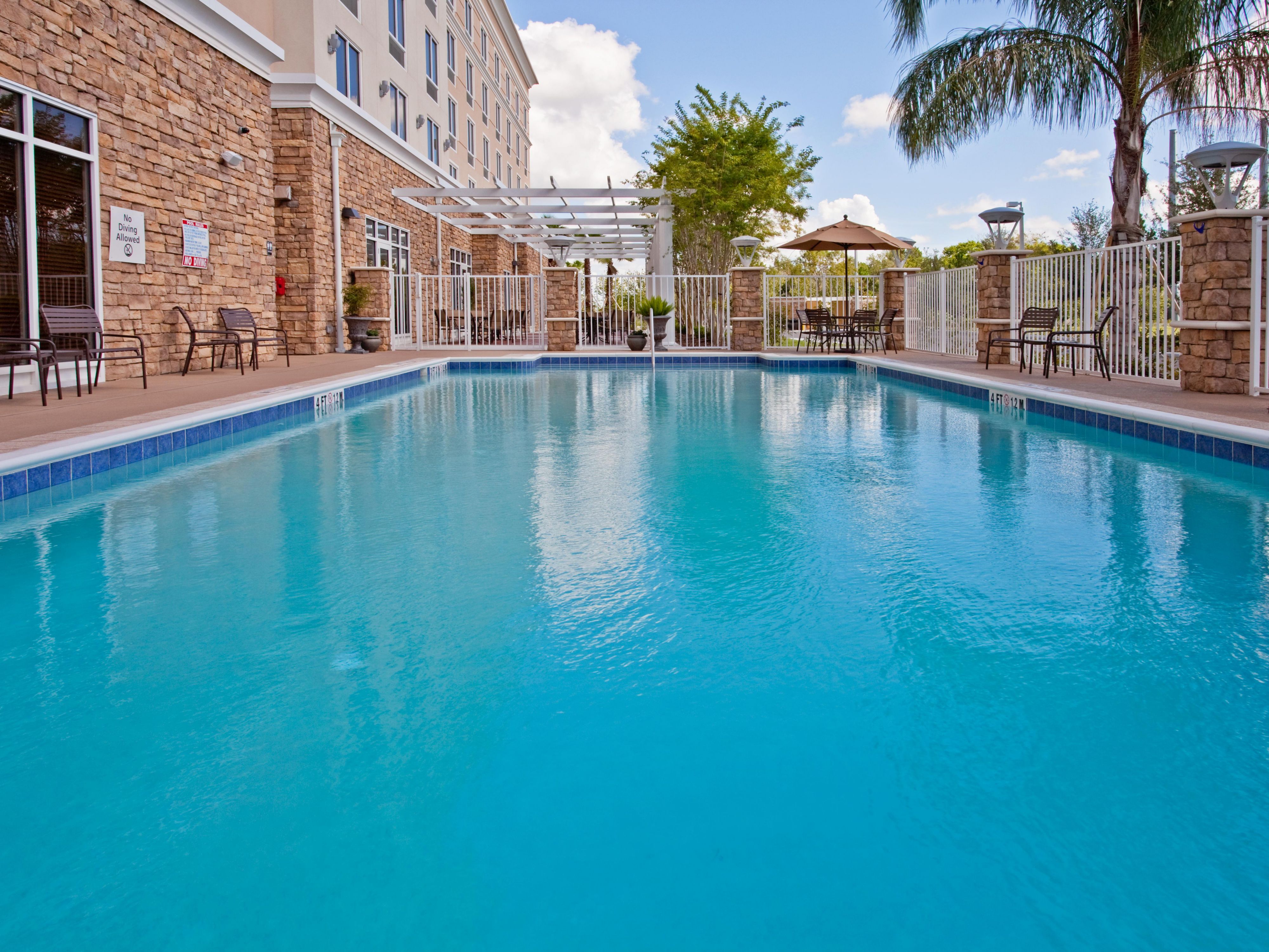 Relax at our hotel with outdoor pool near Kennedy Space Center.