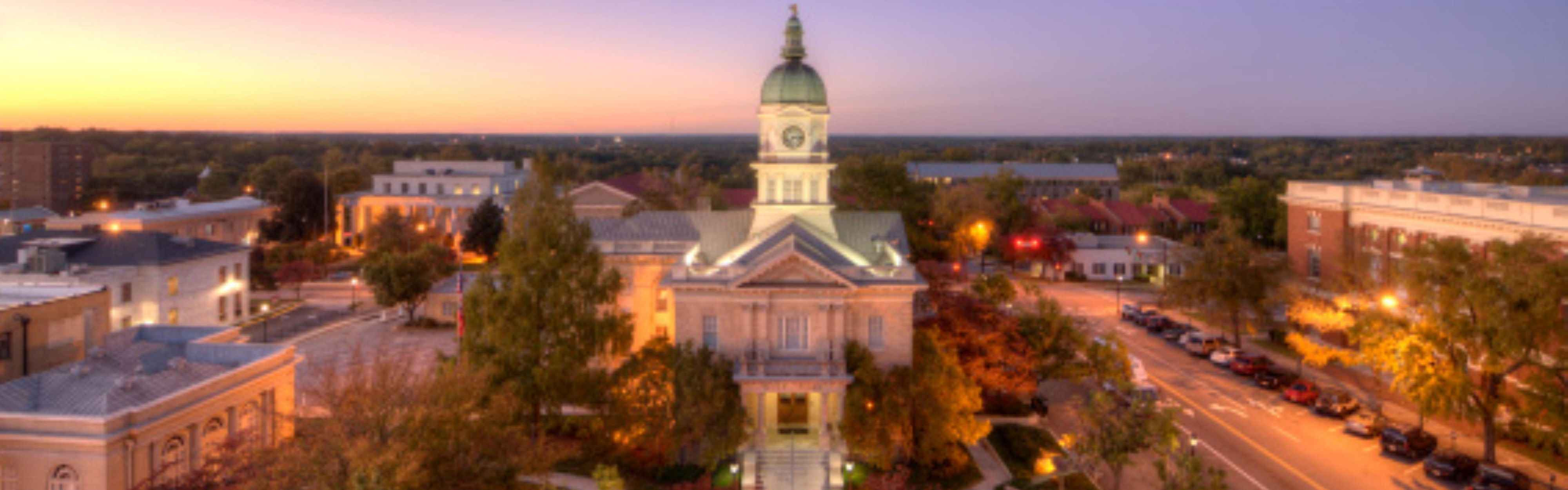An aerial view capturing an illuminated historic civic building.