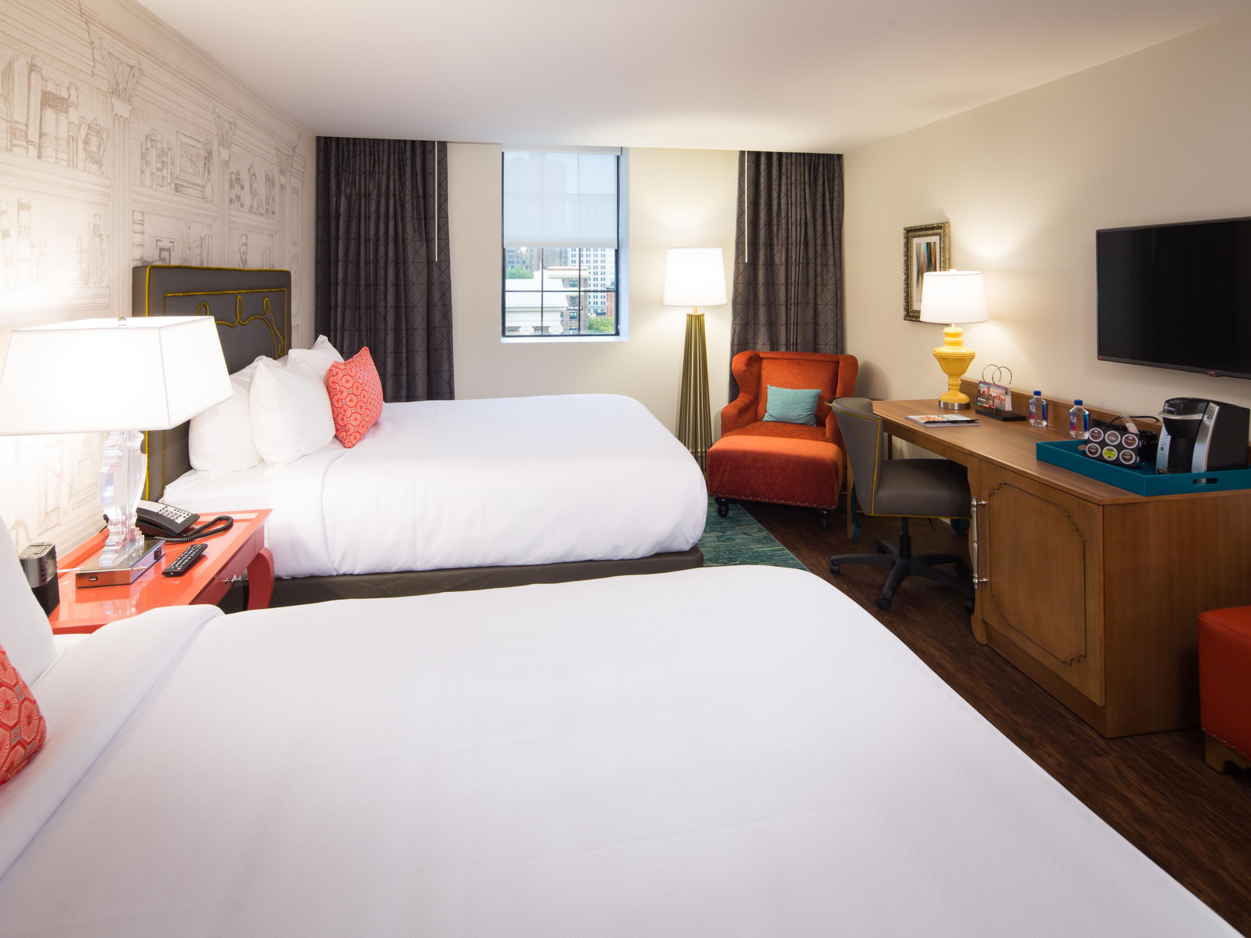Unwind in thoughtfully designed guest rooms featuring plush beds, sleek bathrooms, and locally inspired décor. Enjoy conveniences like mini-fridges, complimentary Wi-Fi, flat-screen TVs, and ergonomic workspaces. 