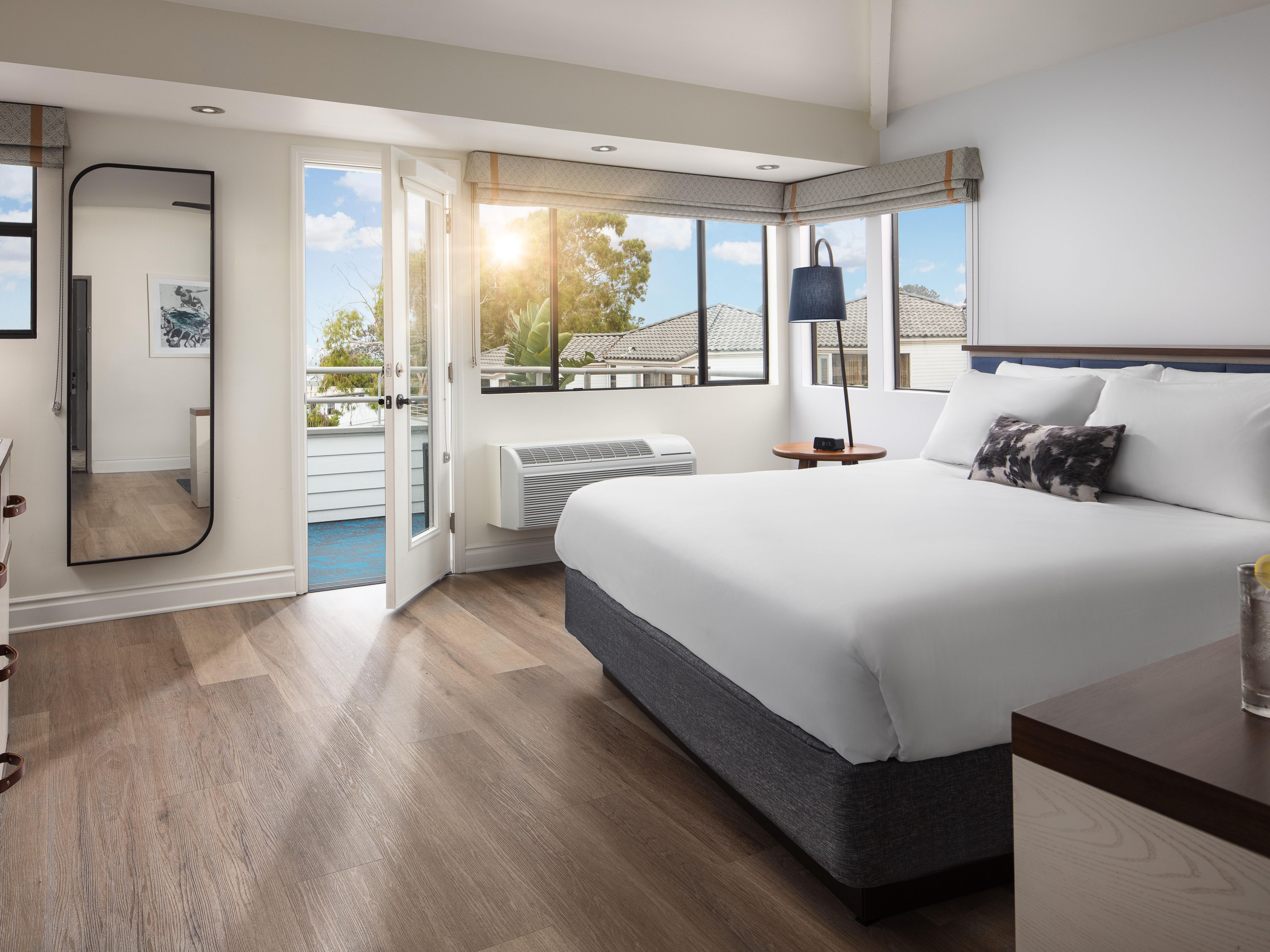 Rooms at Hotel Indigo San Diego Del Mar include practical features such as a tea and coffee maker with complimentary supplies, a mini refrigerator, and a well-lit work desk. Guests can also request connecting rooms, cribs for families, and accessible features designed for comfort and ease.