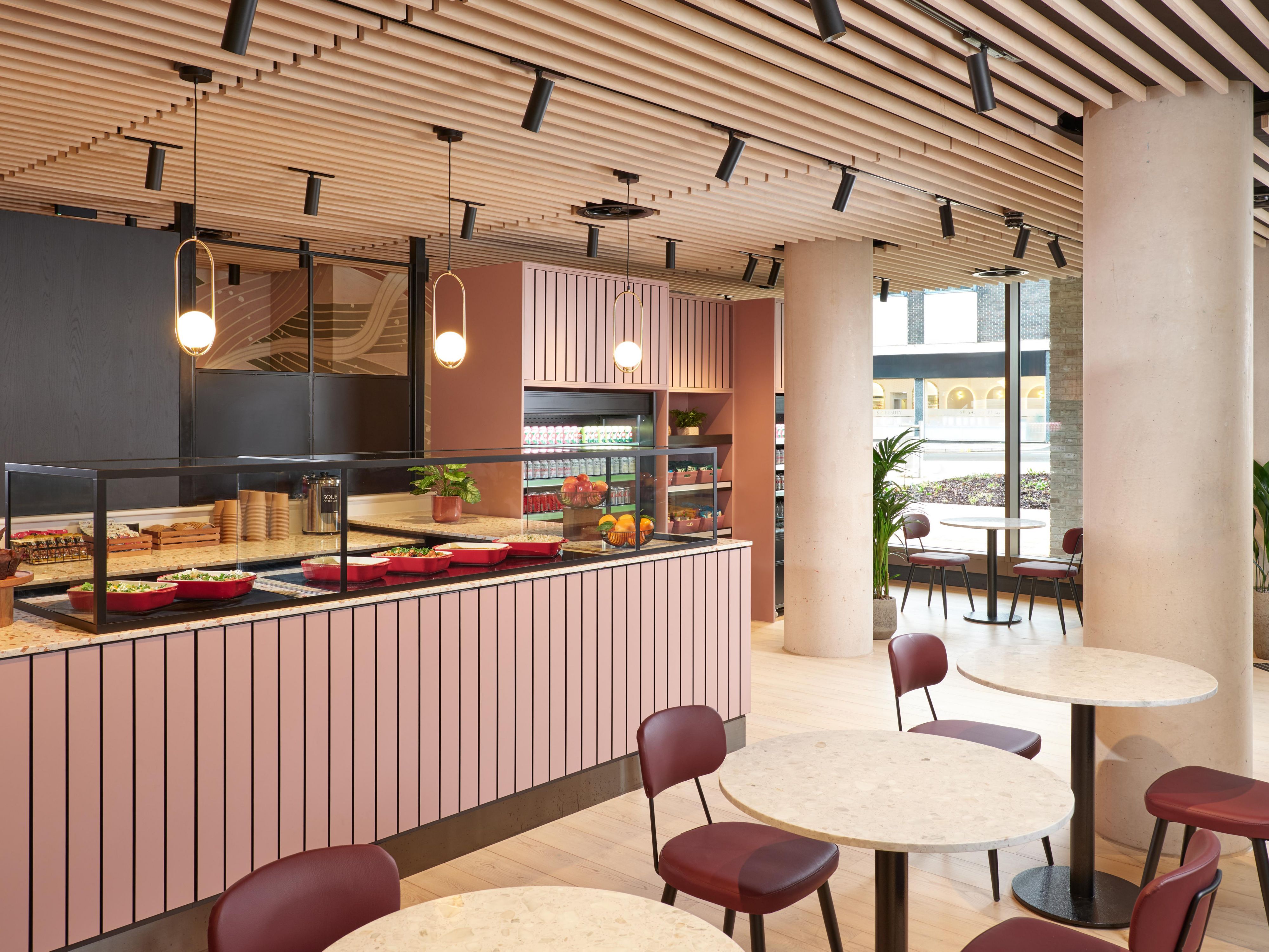 pink themed cafe with plney seating, natural lighting, and refreshments