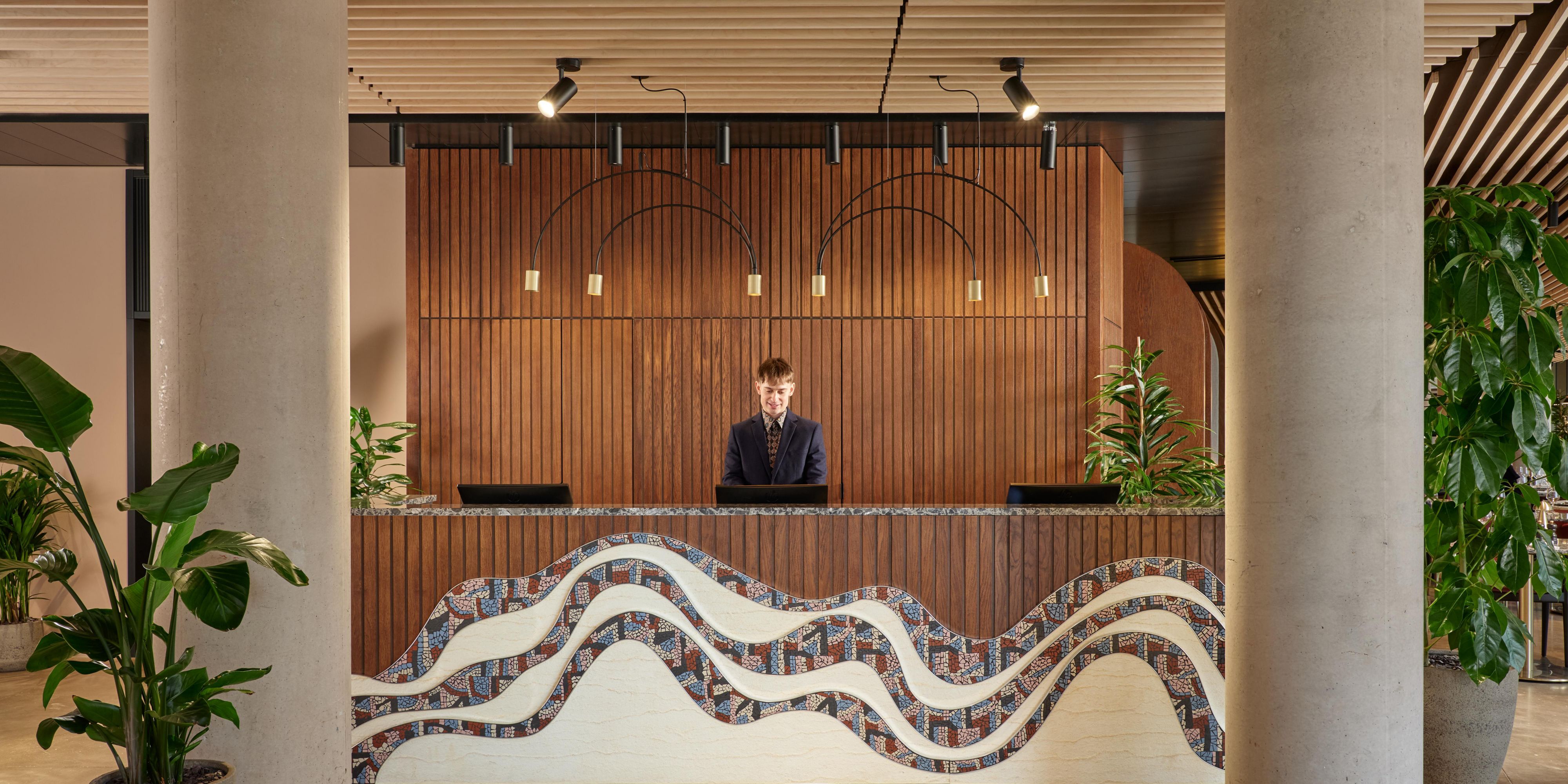 receptionist behind large hotel check in area