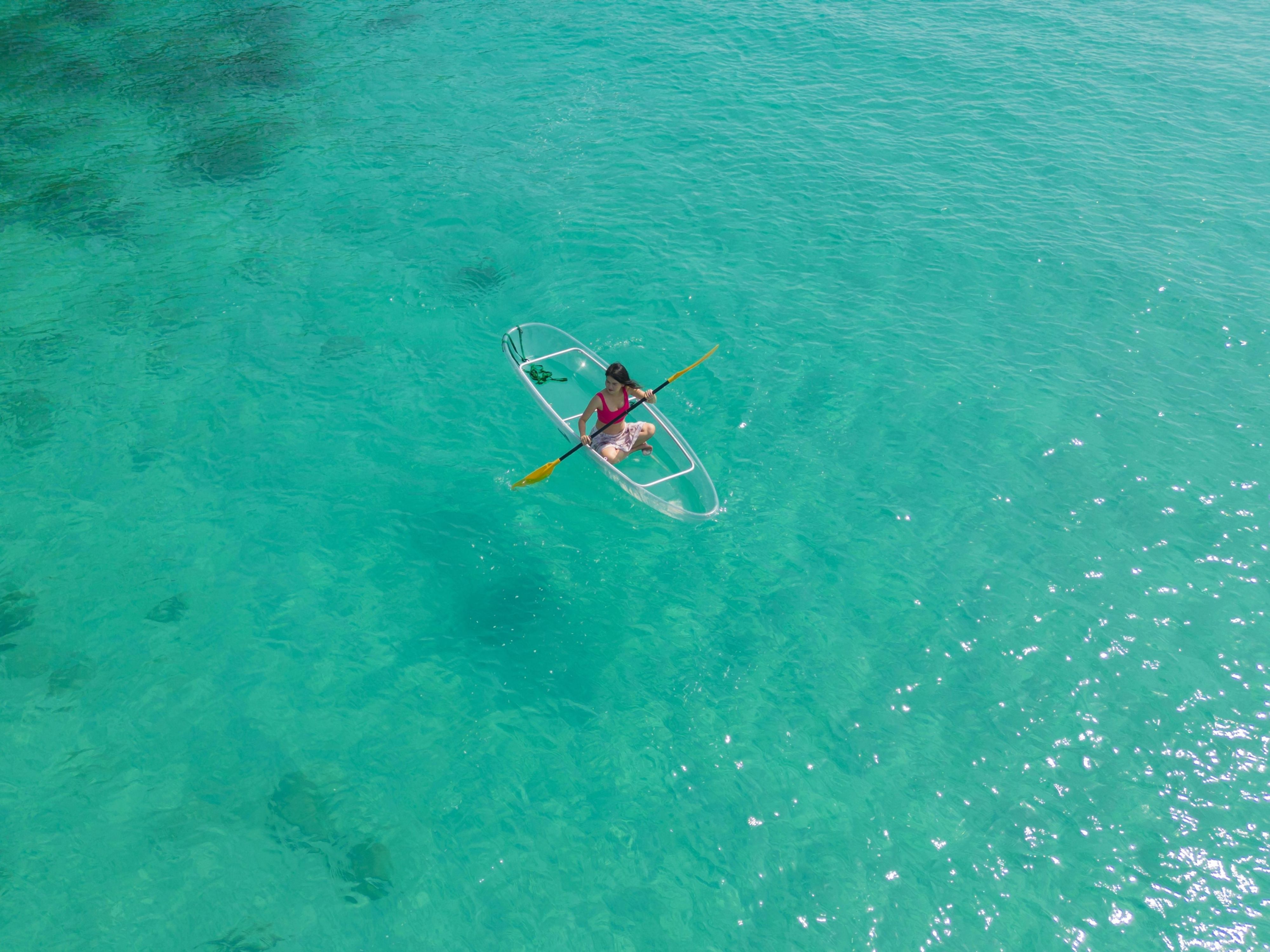 Woman on a clear boat in ocean