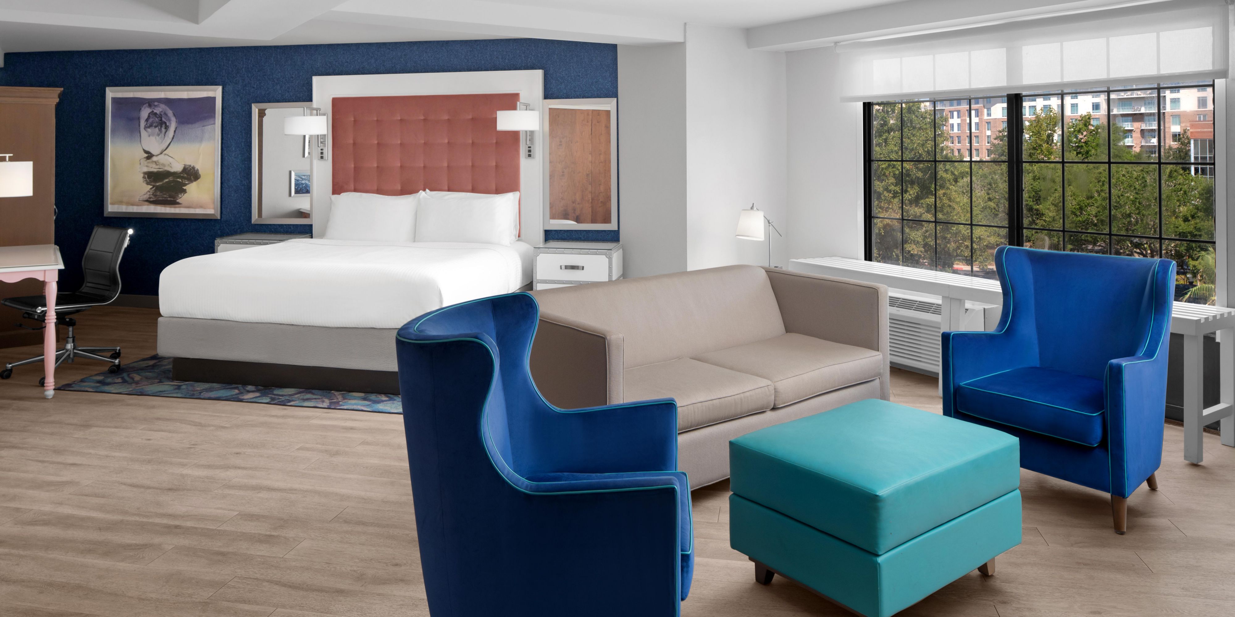 Lounge in a sunlit king suite made for stylish Charleston stays.