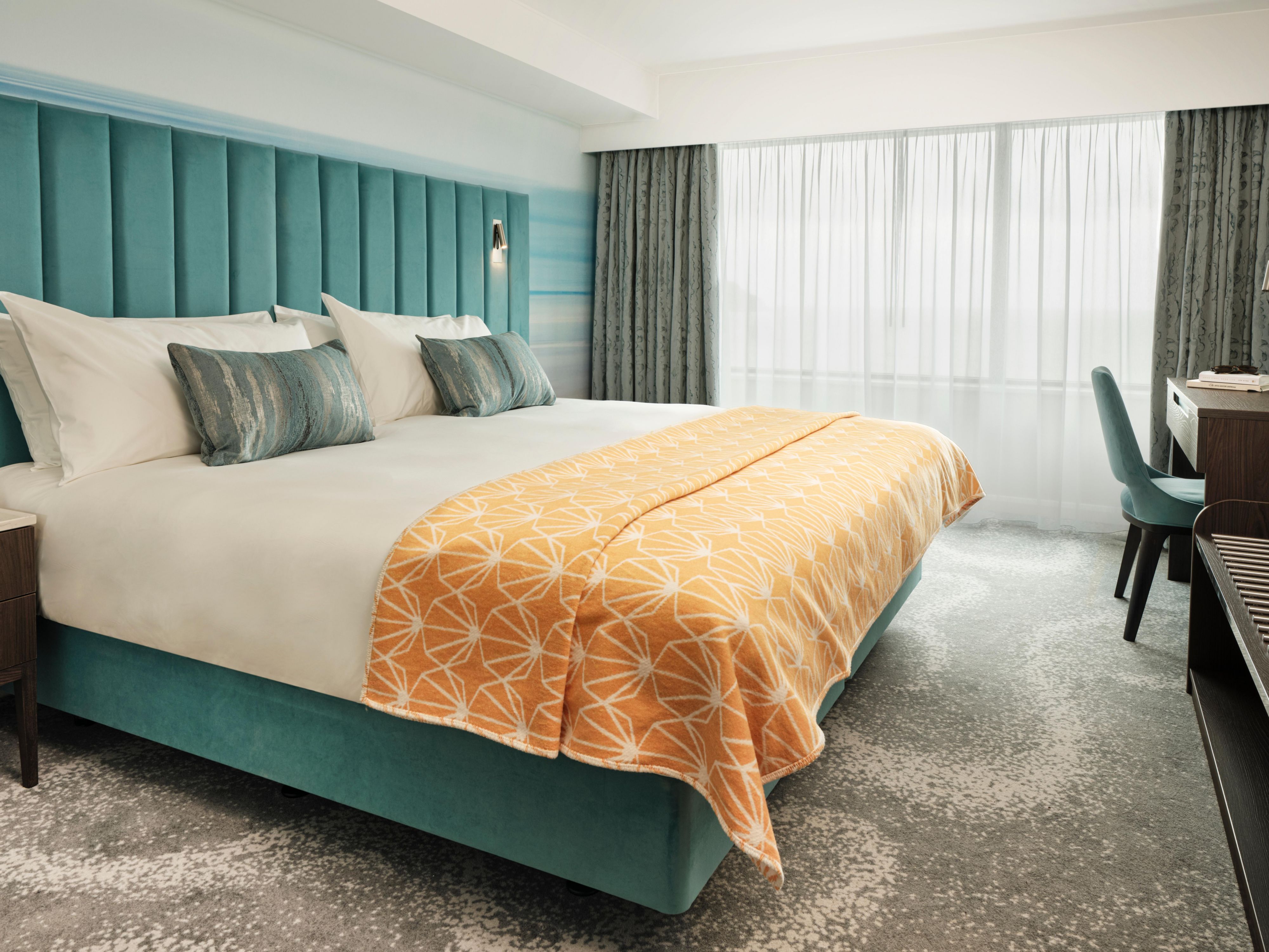 Stay in a vibrant bedroom where modern design meets the Riviera.