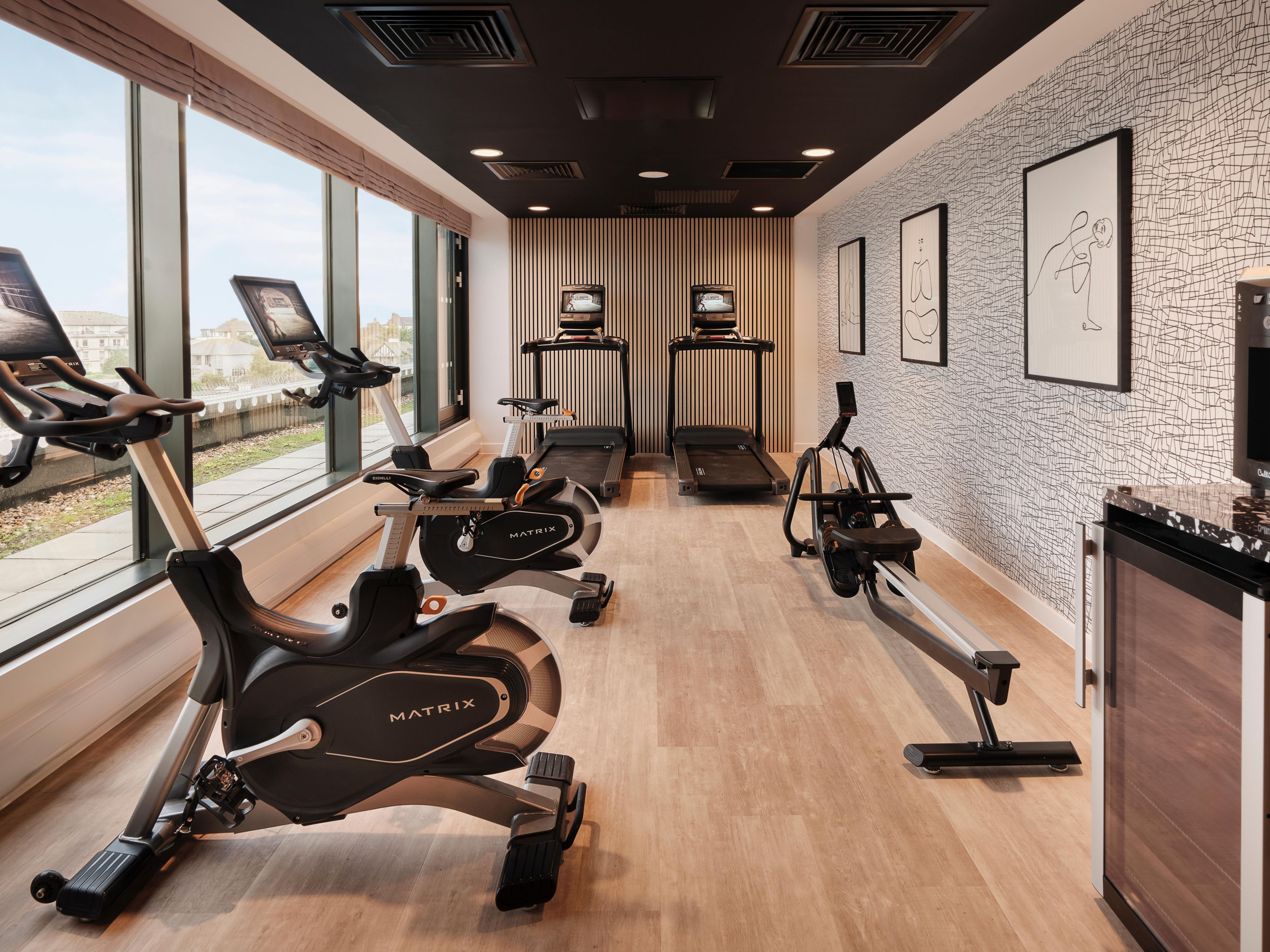 Set in a sleek, design-led space with panoramic sea views, our fitness room invites you to a calm and considered environment to move, reset, and recharge. Framed by floor-to-ceiling windows and warm natural finishes, this boutique gym experience is both energising and refined. 