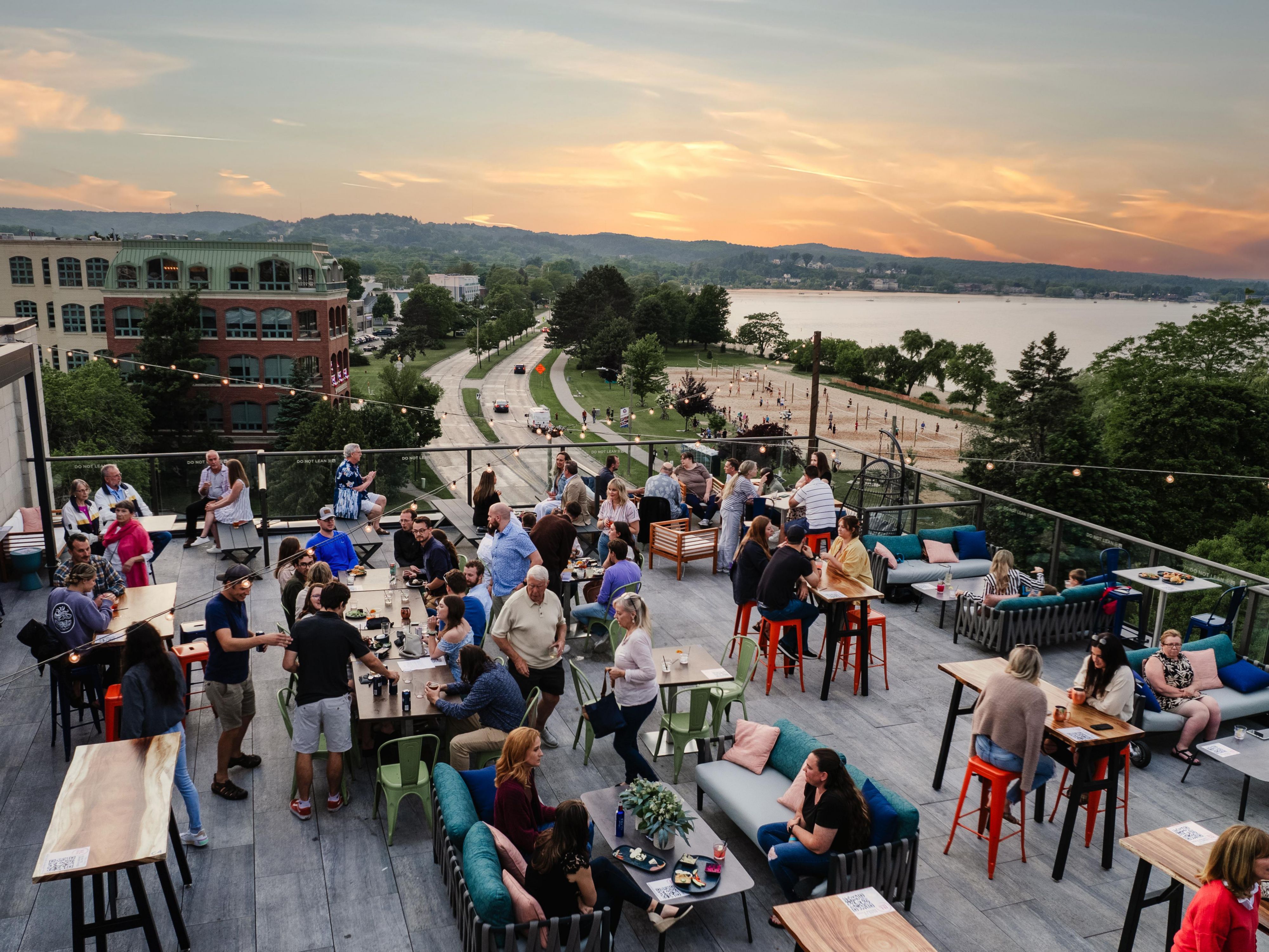 Whether you're sipping on expertly crafted cocktails or enjoying the laid-back atmosphere, the view of Grand Traverse Bay from H&L Social Rooftop is unlike anywhere else in Traverse City. The sunsetting skyline serves as a captivating backdrop for those looking to unwind in style in our warmer months, April to October.