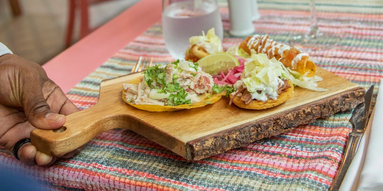 Person delivering appetisers on cutting board