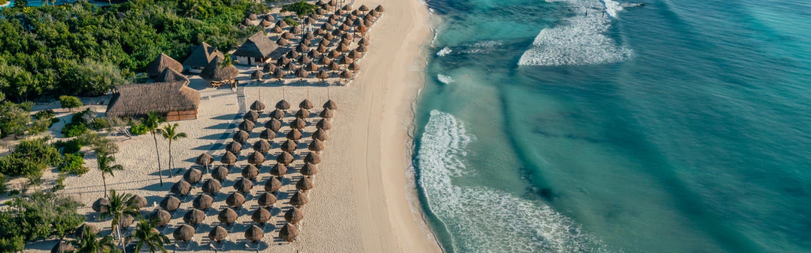 Rows of personal huts on a resort beach