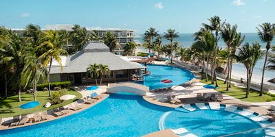 Tropical resort with swimming pools near the beach.