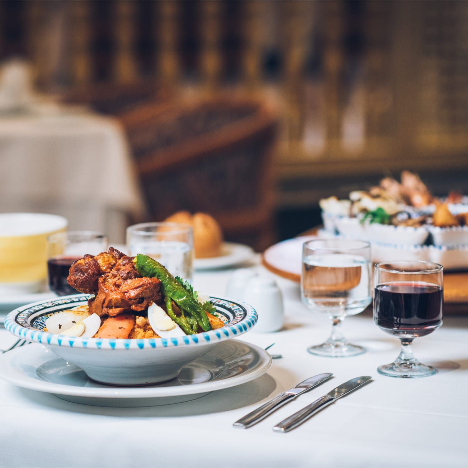 White tablecloth meal with food and wine