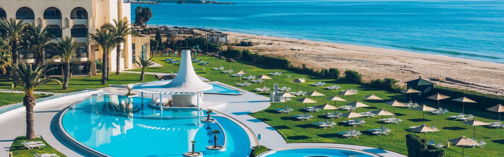 Aerial view of beachside pool and private cabanas