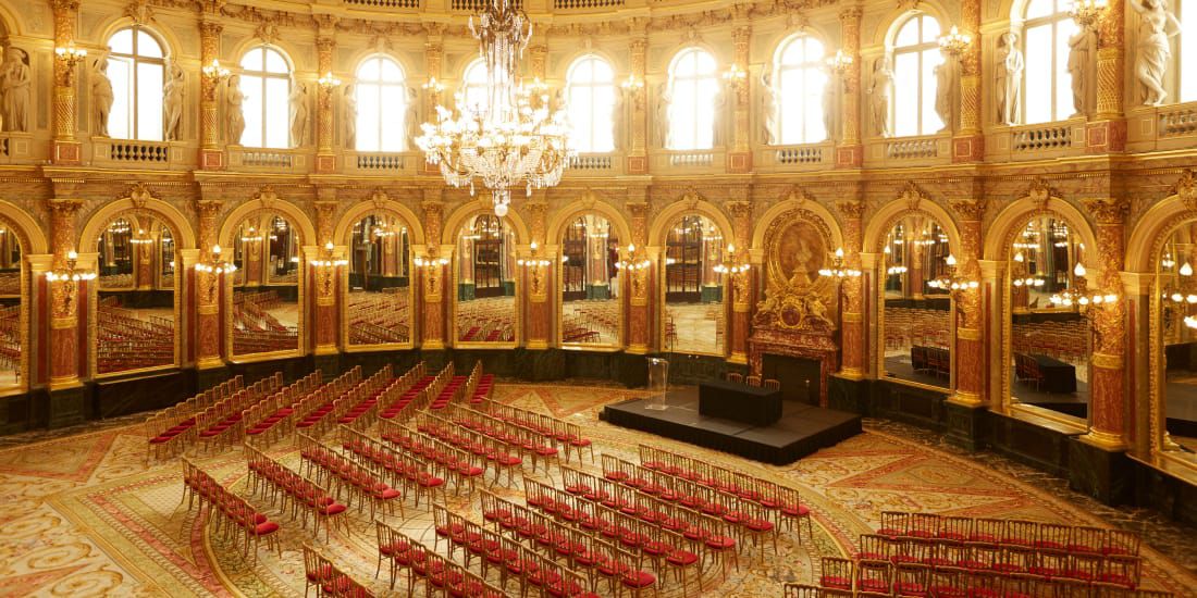 opulent ballroom set up for classroom-style meeting