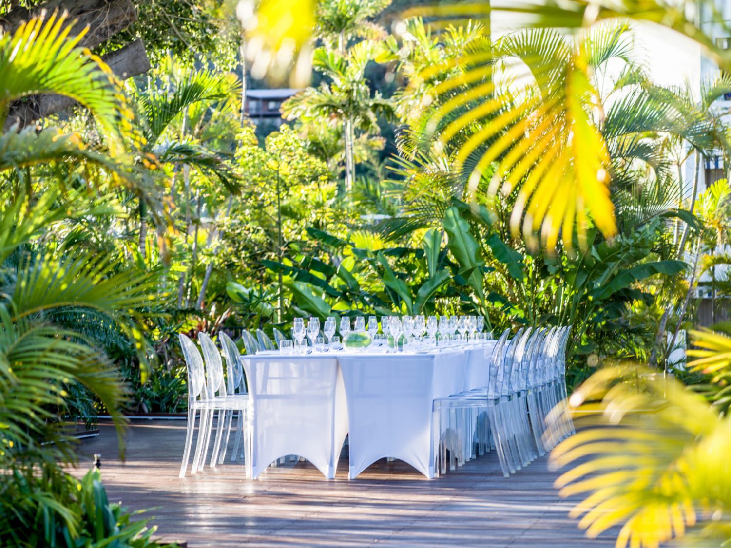 outdoor boardroom setup surrounded by tropical foliage