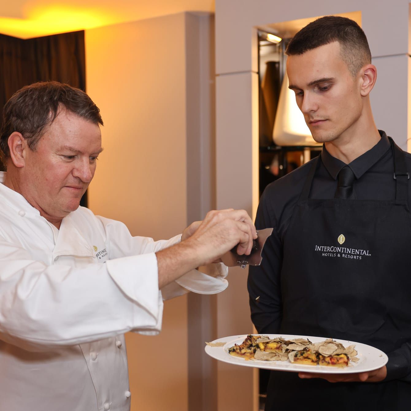 chef putting finishing touches on a plate