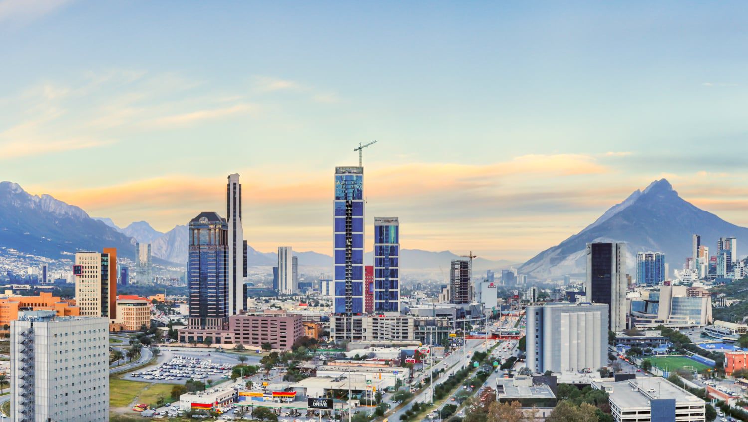 Views of a sprawling business and industrial centre fringed by mountains