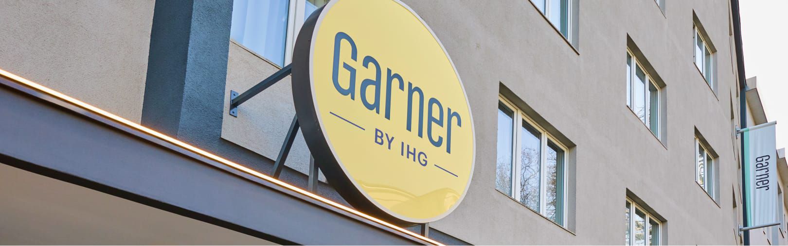 A Garner hotel facade and iconic yellow sign.