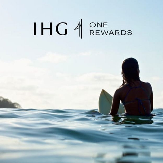 Image of IHG One Rewards woman surfing with IHG One Rewards logo