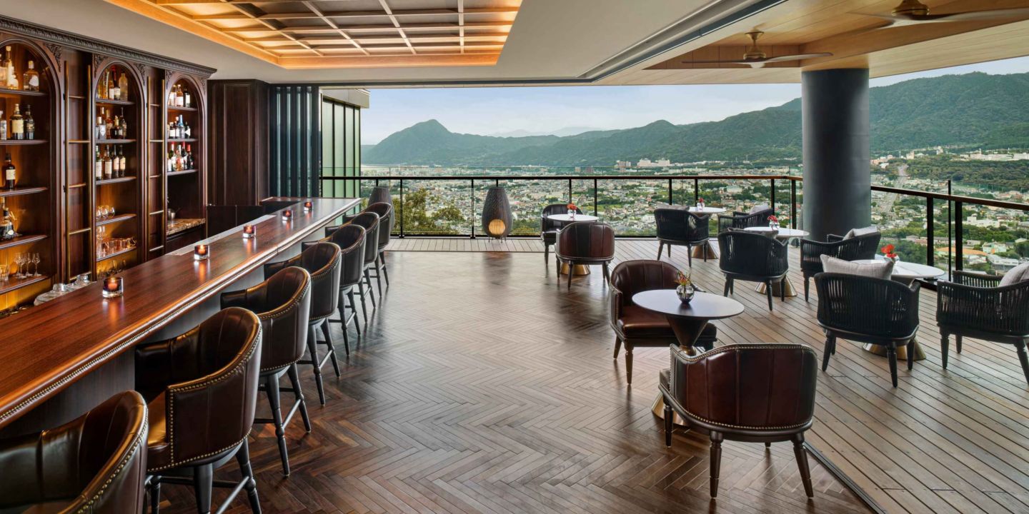 A covered outdoor bar overlooking mountains and a city near Gifu Japan