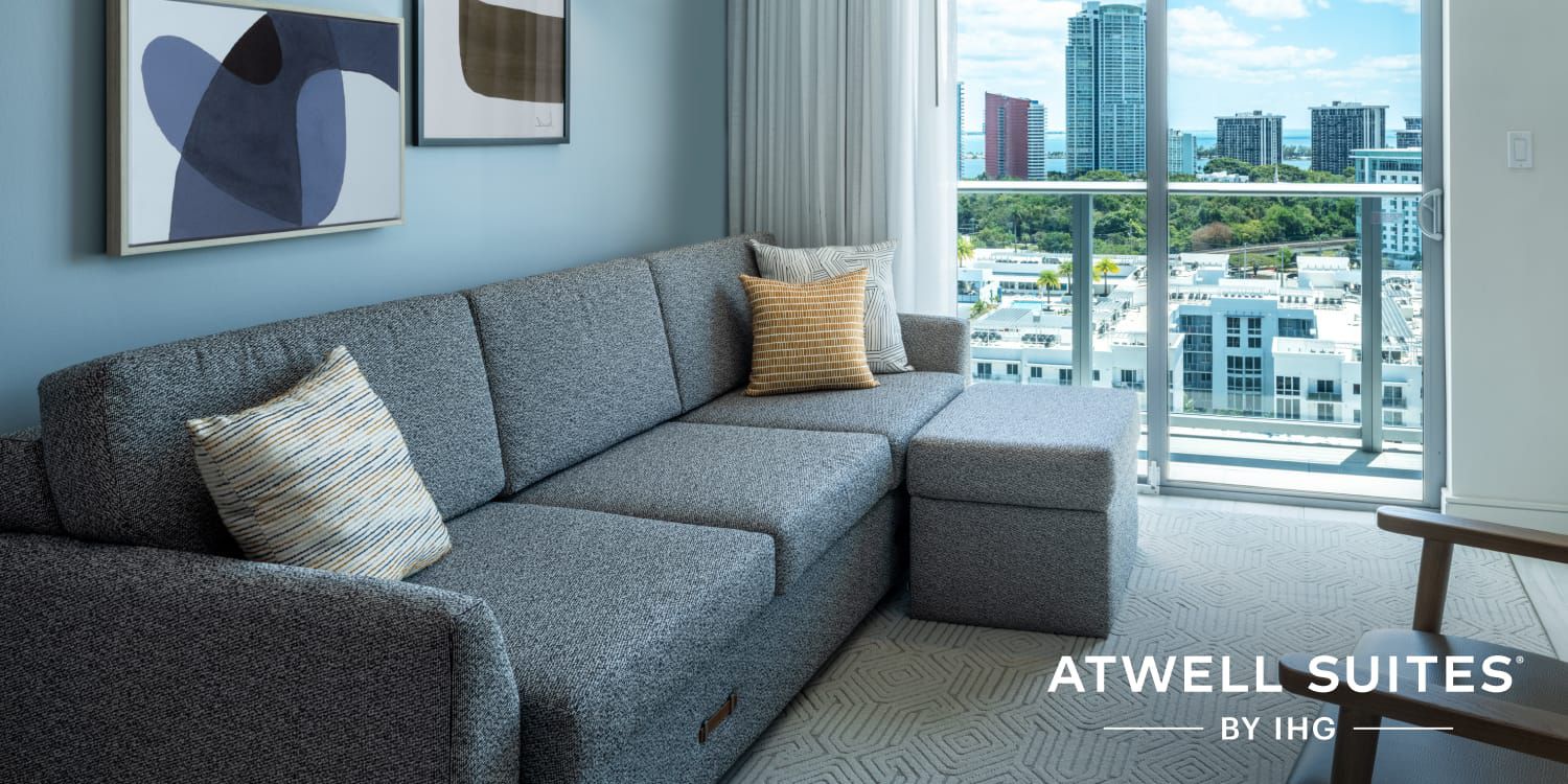 Seating area of hotel suite with balcony view