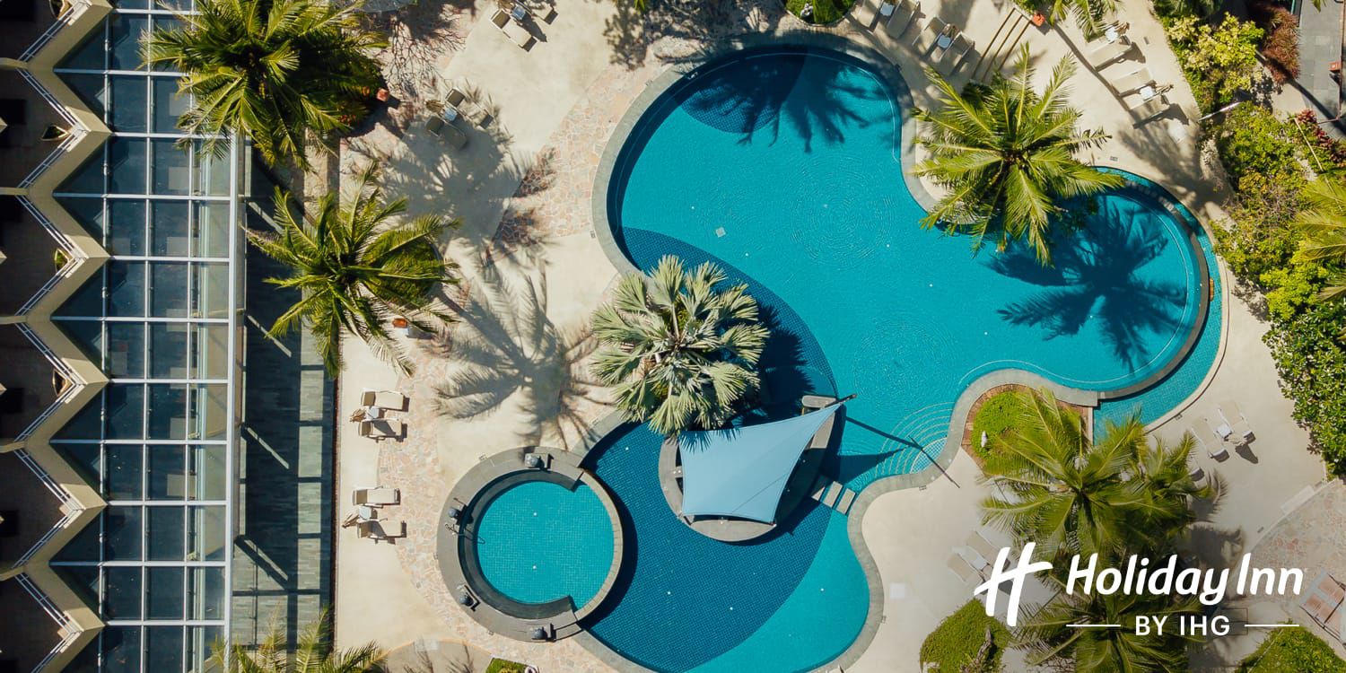 Aerial view of swimming pool and palm trees