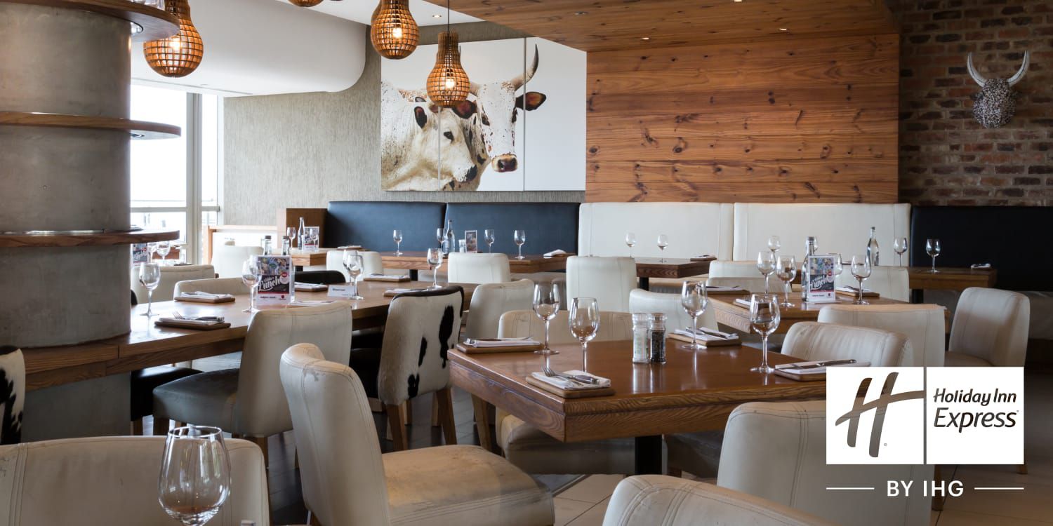 Interior of restaurant with leather seating and wood walls