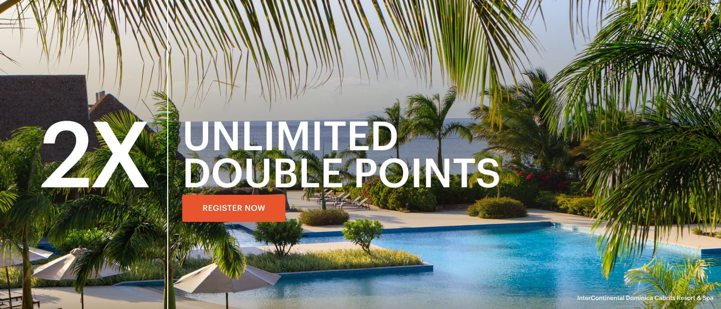 A pool with palm trees overlooking the beach