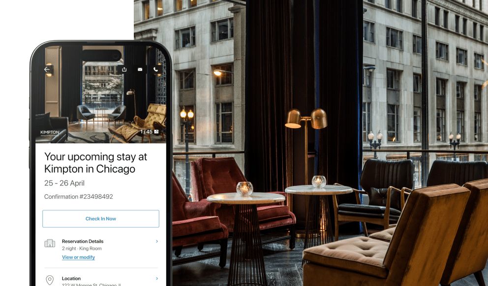 IHG app upcoming stay information on phone screen, upscale bar lounge seating area