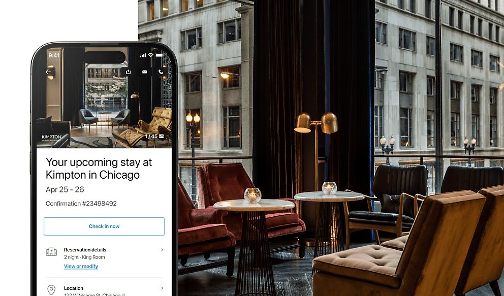 IHG app upcoming stay information on phone screen, upscale bar lounge seating area