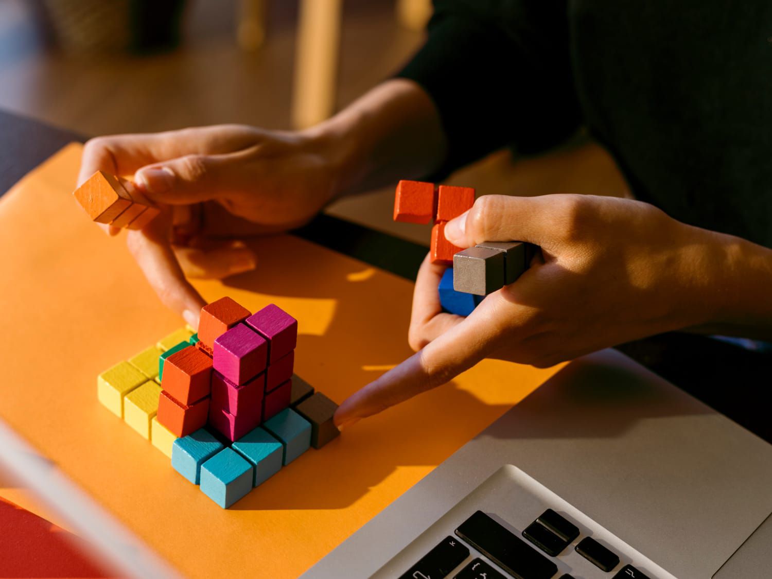 Hands playing with colourful fidget puzzle