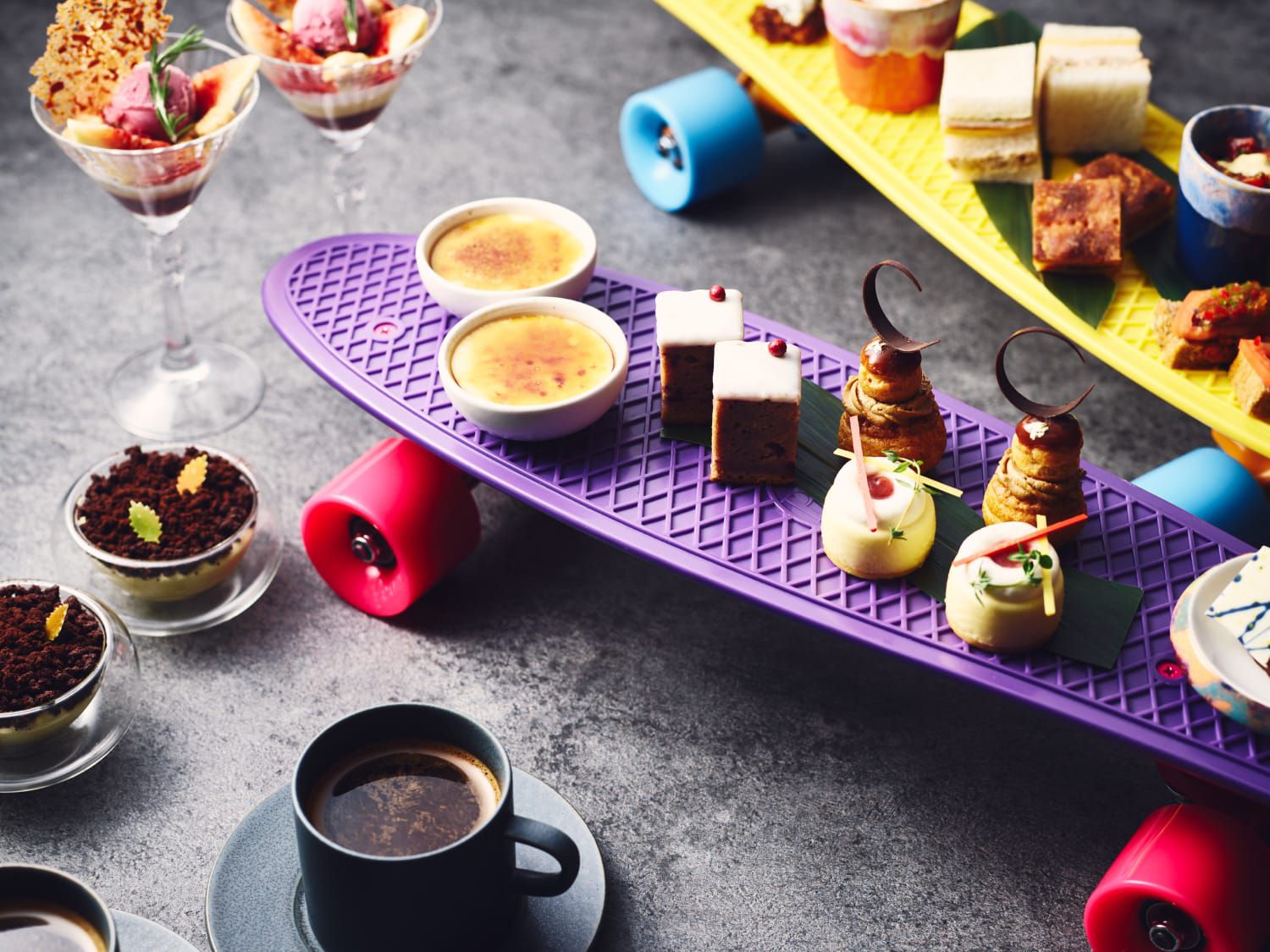 Fancy small bites of colourfully plated food on skateboards
