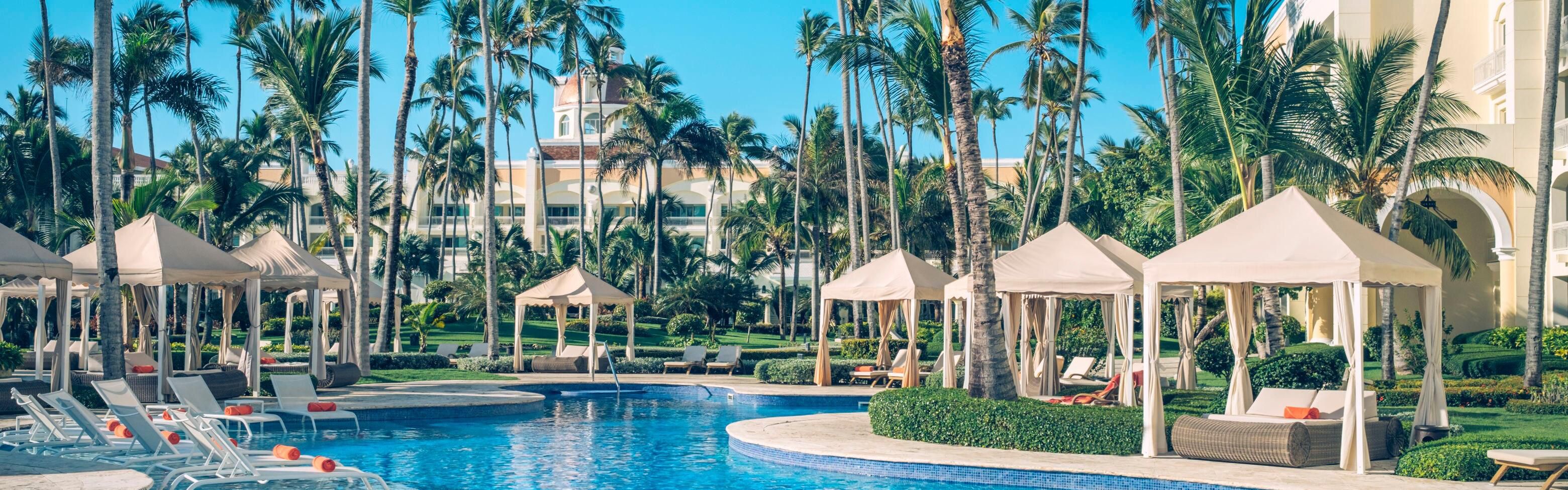 Lounge poolside under palms at this Bávaro Beach adults retreat.