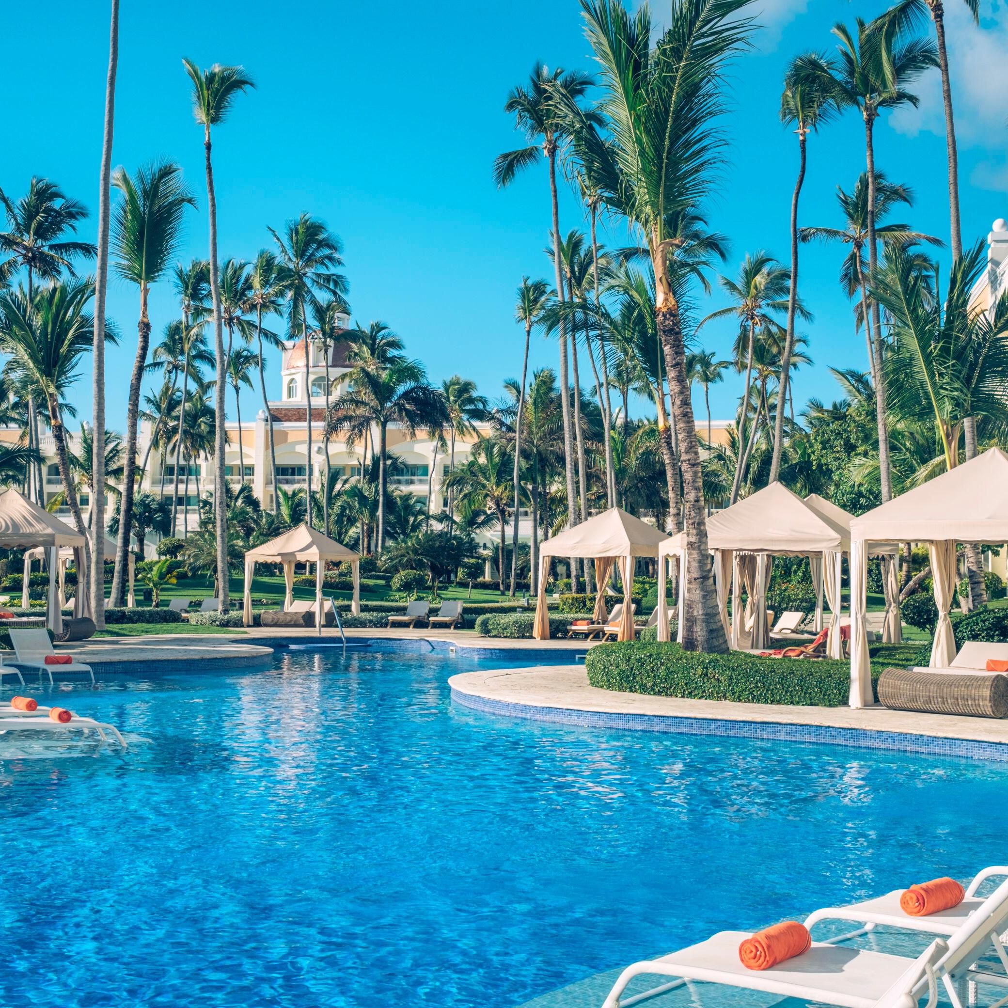 Lounge poolside under palms at this Bávaro Beach adults retreat.