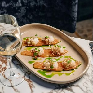 Elegant plated appetizer with wine on marble table