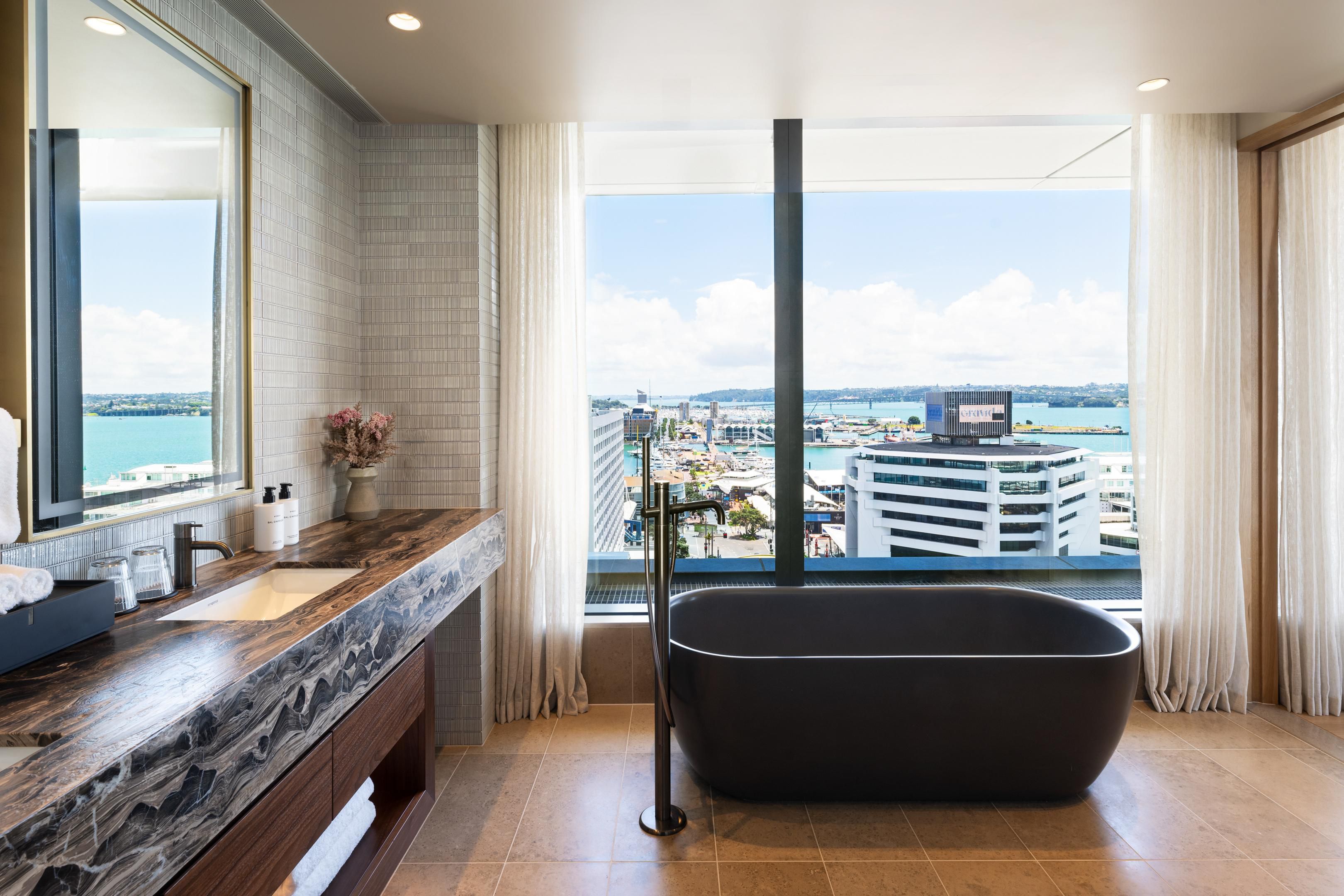 Suite bathroom with tub and modern amenities