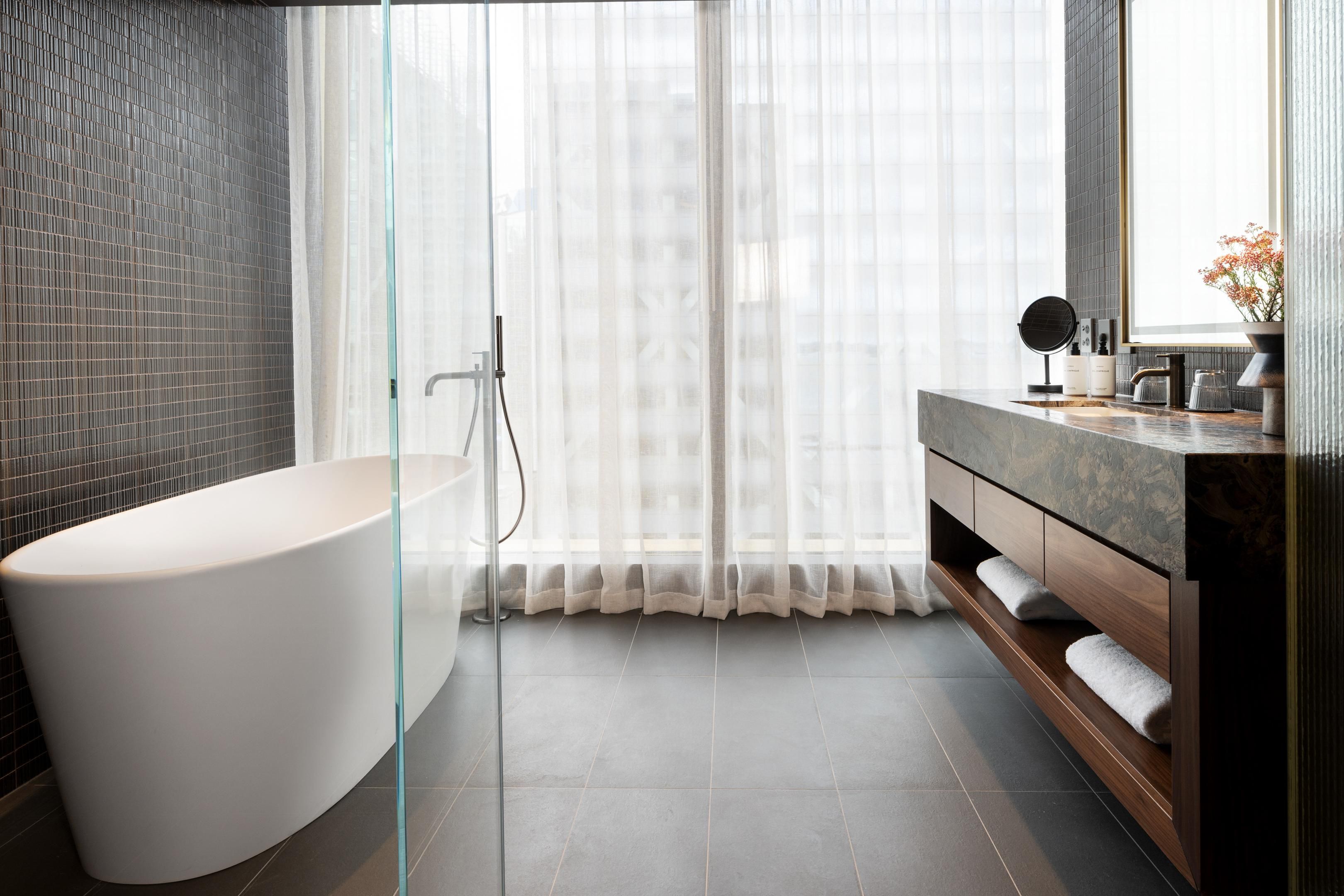 Junior suite bathroom with tub and walk-in shower