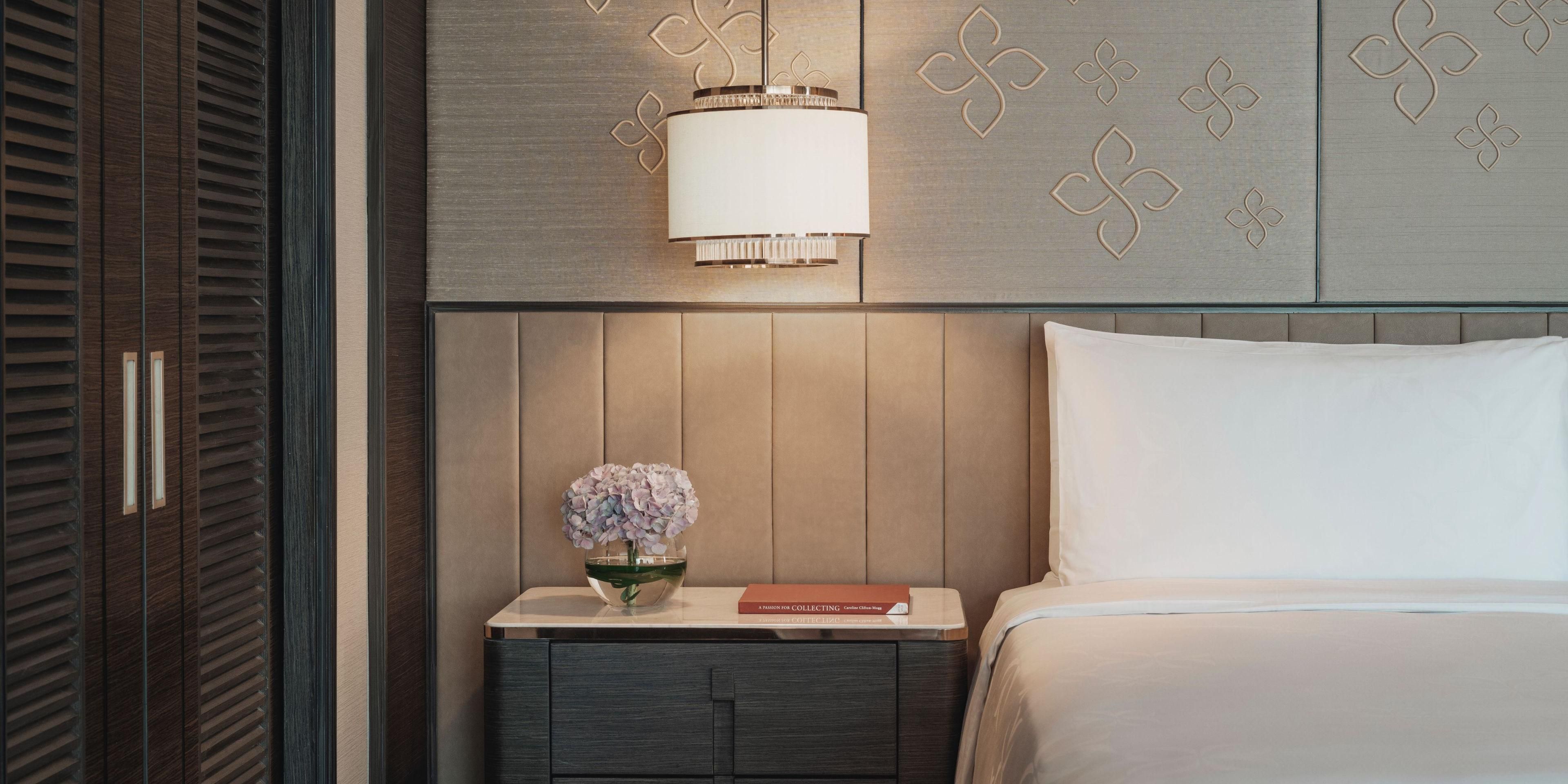 Experience Thai-inspired elegance at InterContinental Bangkok. Each room and suite showcases pastel silk-embroidered bedheads, handmade artwork of floating flowers, and custom furniture. Wooden parquet floors add warmth, while deep soaking tubs and rain showers ensure ultimate relaxation, all with stunning Bangkok city views.