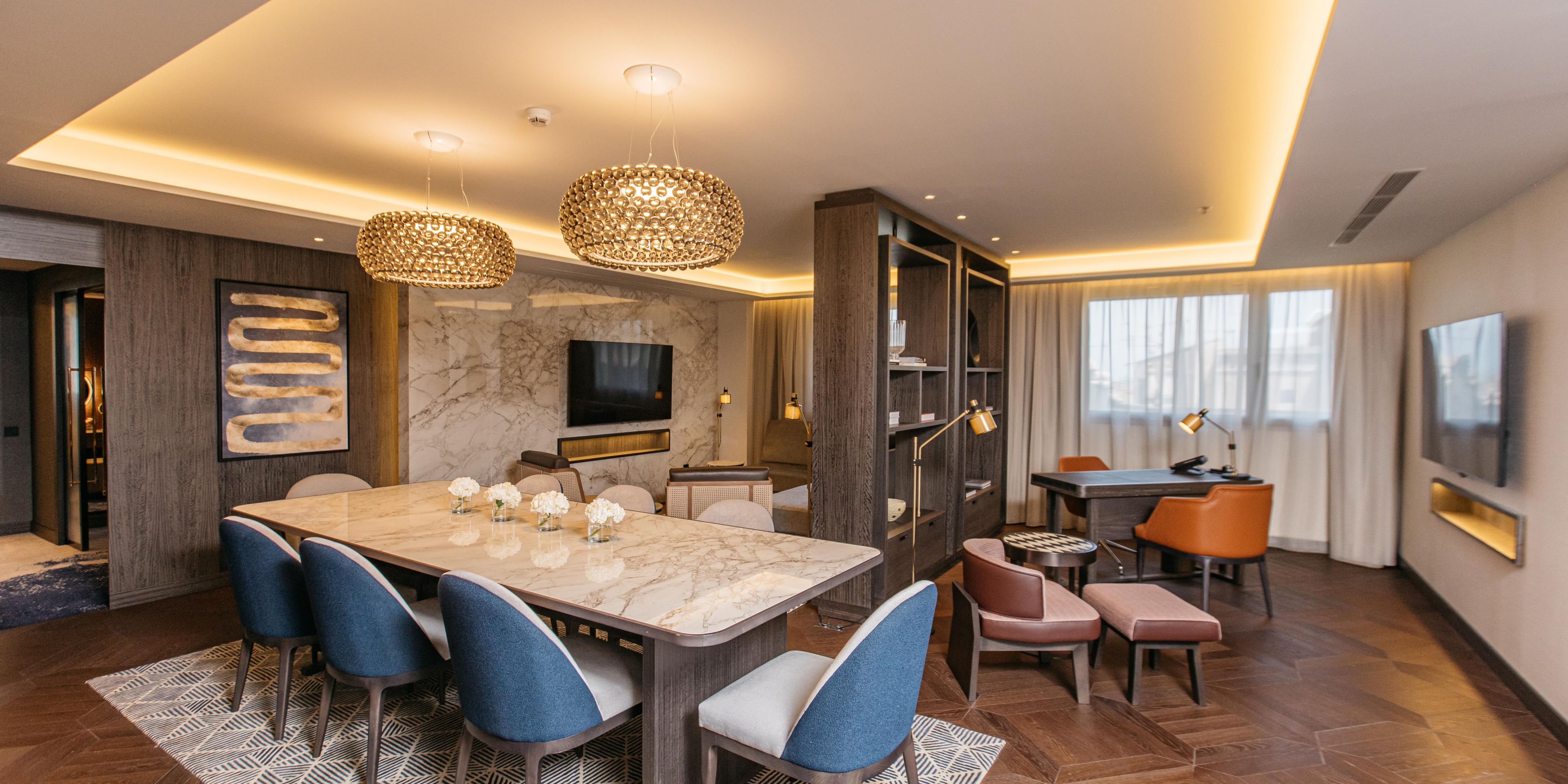 The Presidential Suite at InterContinental® Barcelona is the largest and most luxurious room, featuring a spacious living-dining area with a kitchen, two bedrooms, and refined décor. The main bedroom has a king-size bed and walk-in closet, while the second offers twin beds. Located on the 5th floor for a serene, luxury experience.