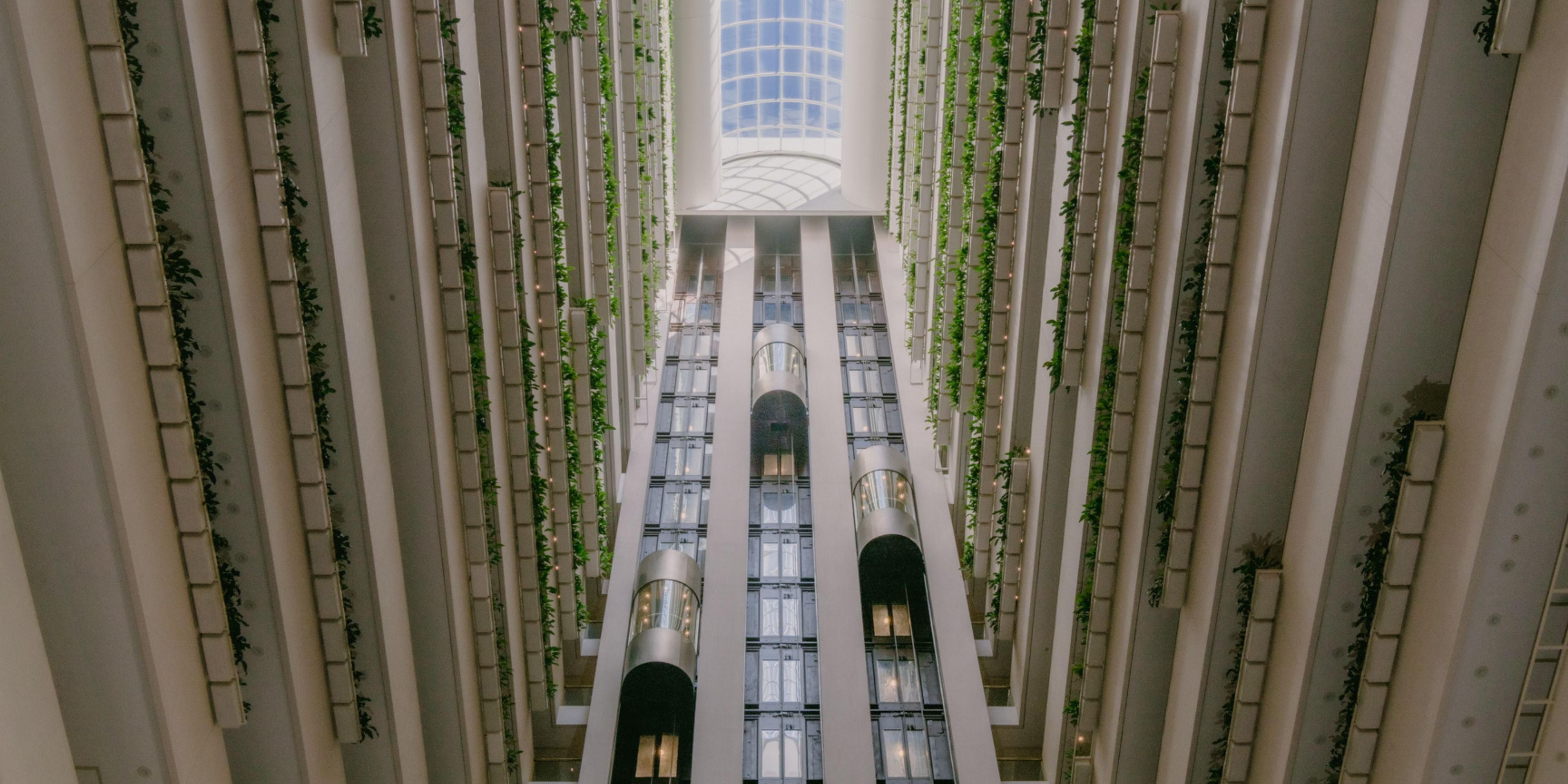 The view of the atrium and lift capsules from the hotel lobby