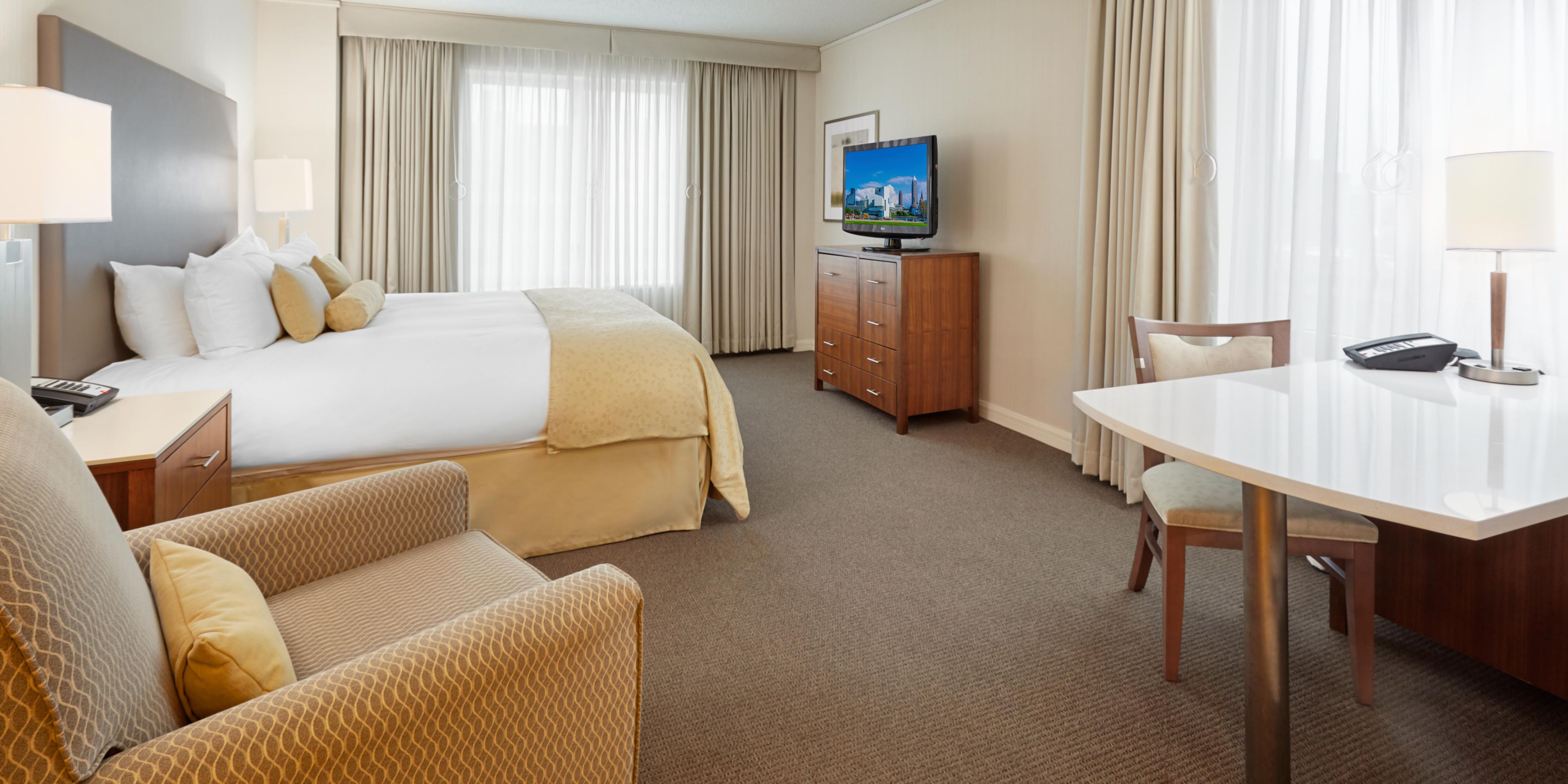 Well-appointed guest room with recliner chair and dining table