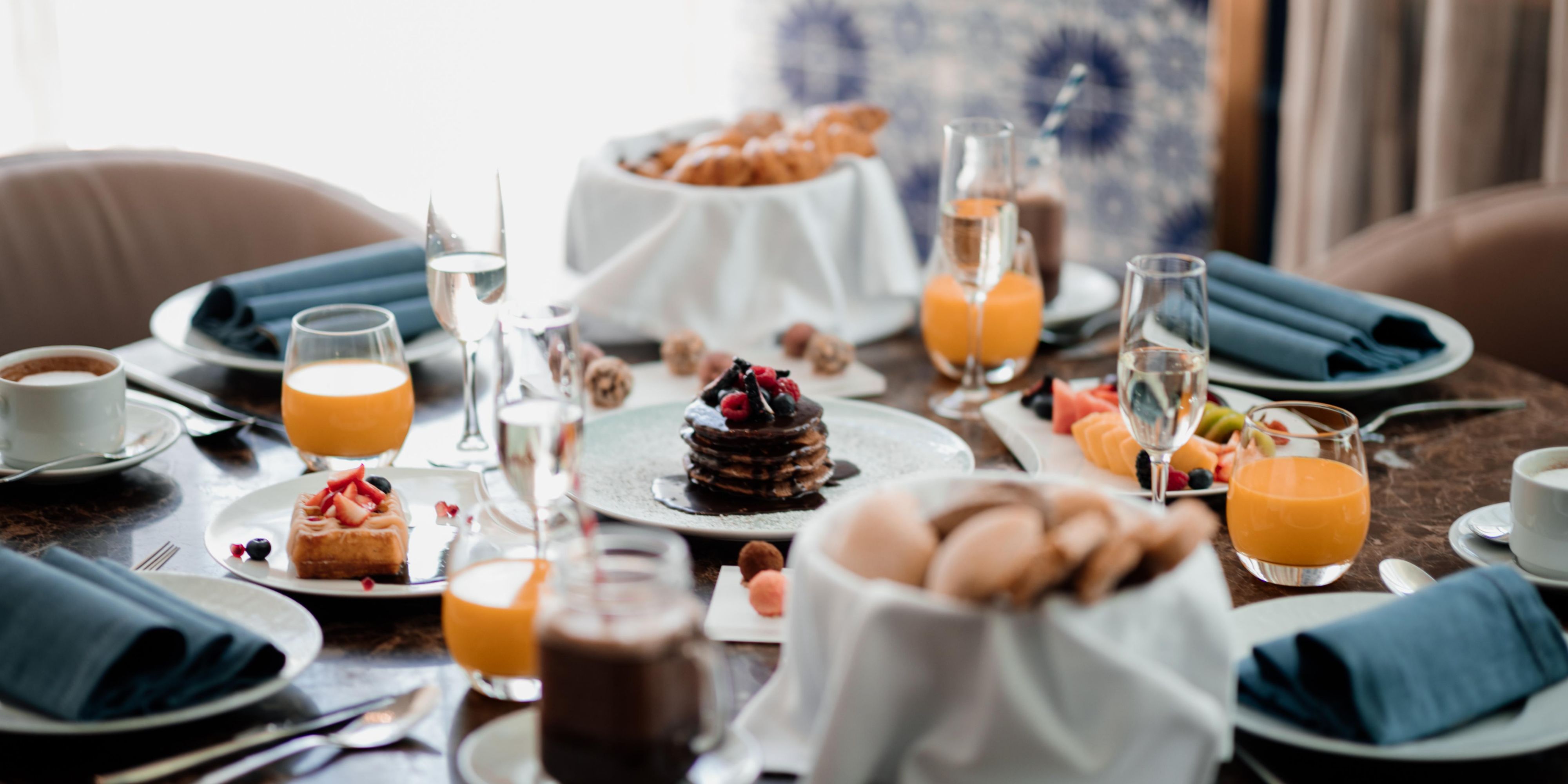 Gather friends and family around a generous Sunday brunch table to enjoy a unique brunch menu, highlighting local ingredients and seasonal flavors.