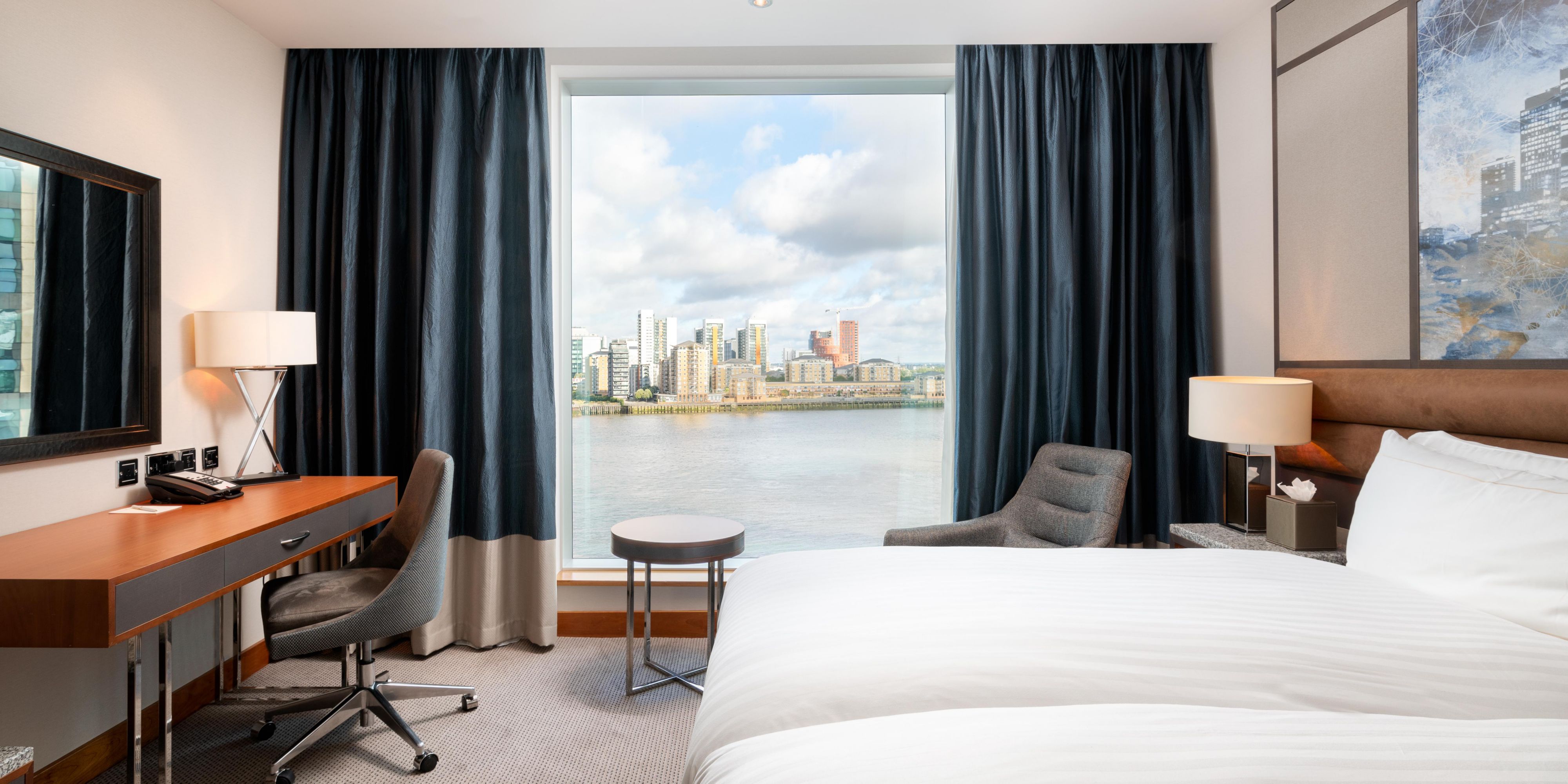 Relax in our sleek rooms and suites, offering stunning views over the River Thames, Canary Wharf, and The O2 through floor-to-ceiling windows and luxurious in-room amenities.