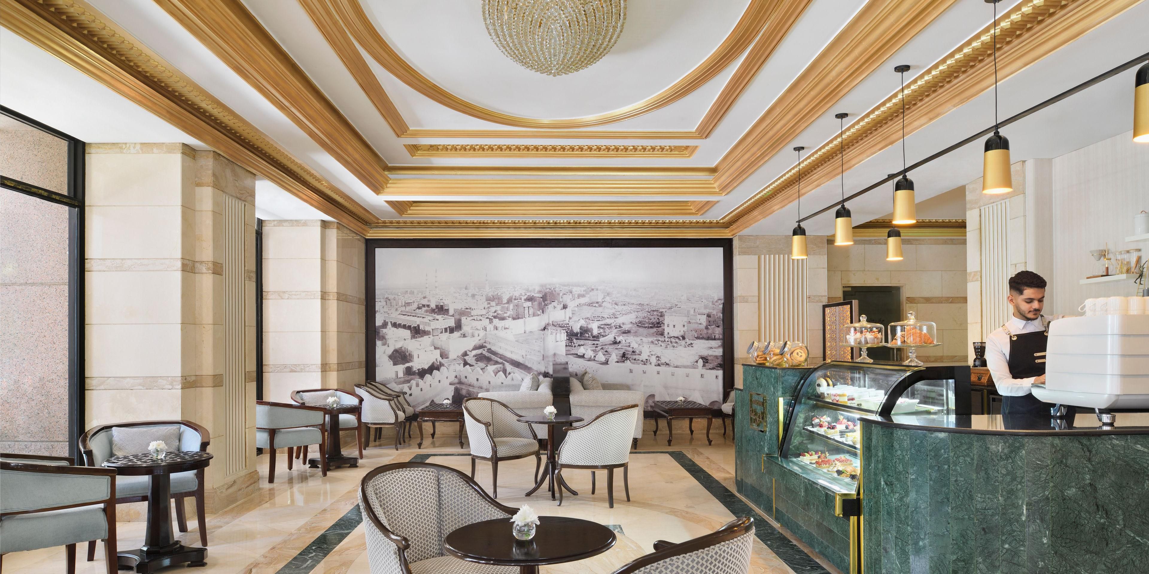 Unwind with a coffee or tea break near Haram at Taiba Café. Enjoy the rich aroma of freshly ground coffee, perfectly complemented with a delectable dessert, or delight in our traditional high tea, featuring warm scones with jam, mini pastries, and dainty sandwiches. Explore a range of beverages, such as date and toffee milkshakes and hot sahlab.