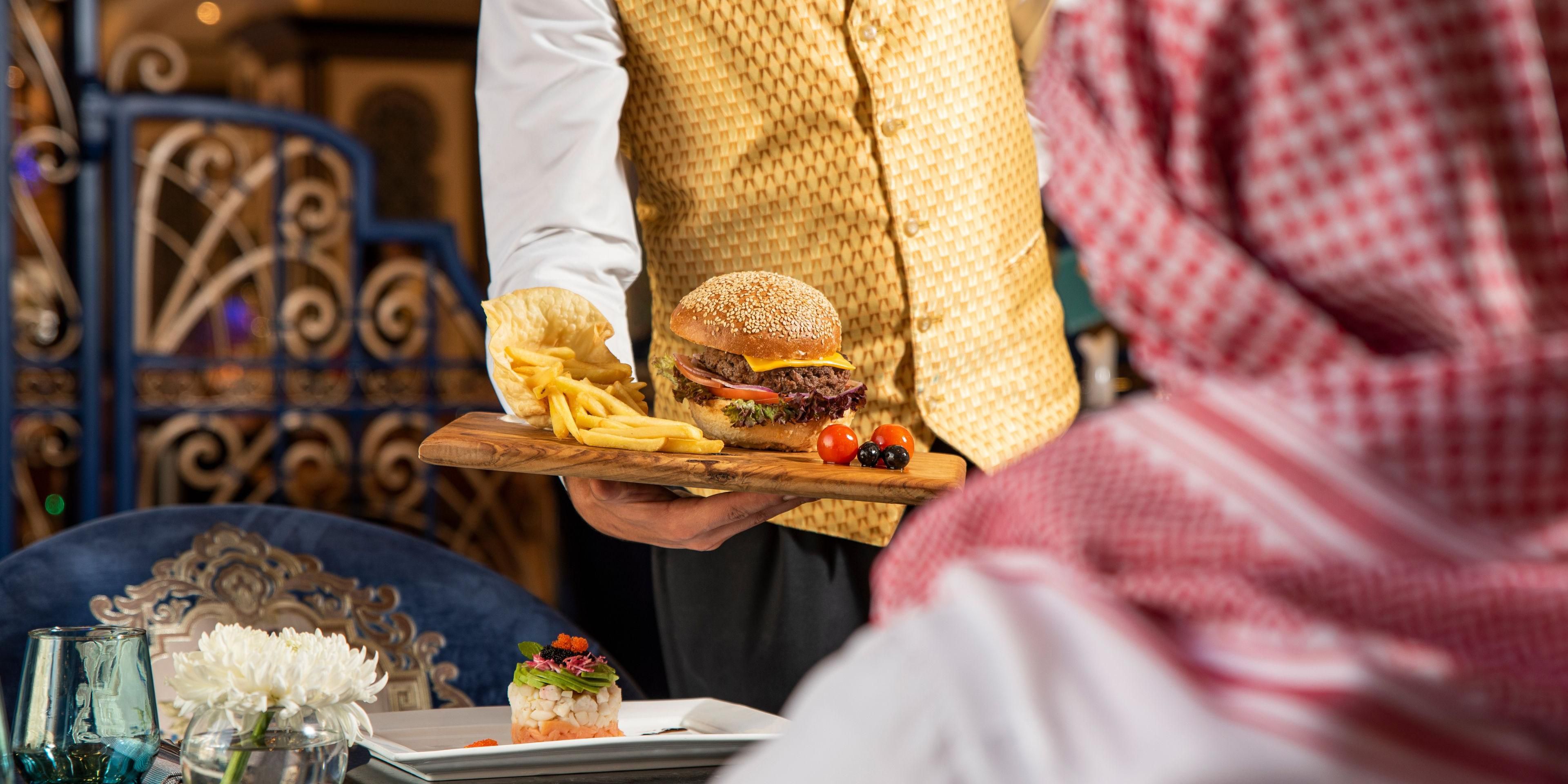 Savour the ultimate culinary combination at ZamZam Café, where delectable gourmet burgers are served alongside irresistible seasoned fries and refreshing coleslaw. Complement your meal with a selection of chilled soft drinks or freshly squeezed juices, all while enjoying breathtaking views of the Holy Mosque.