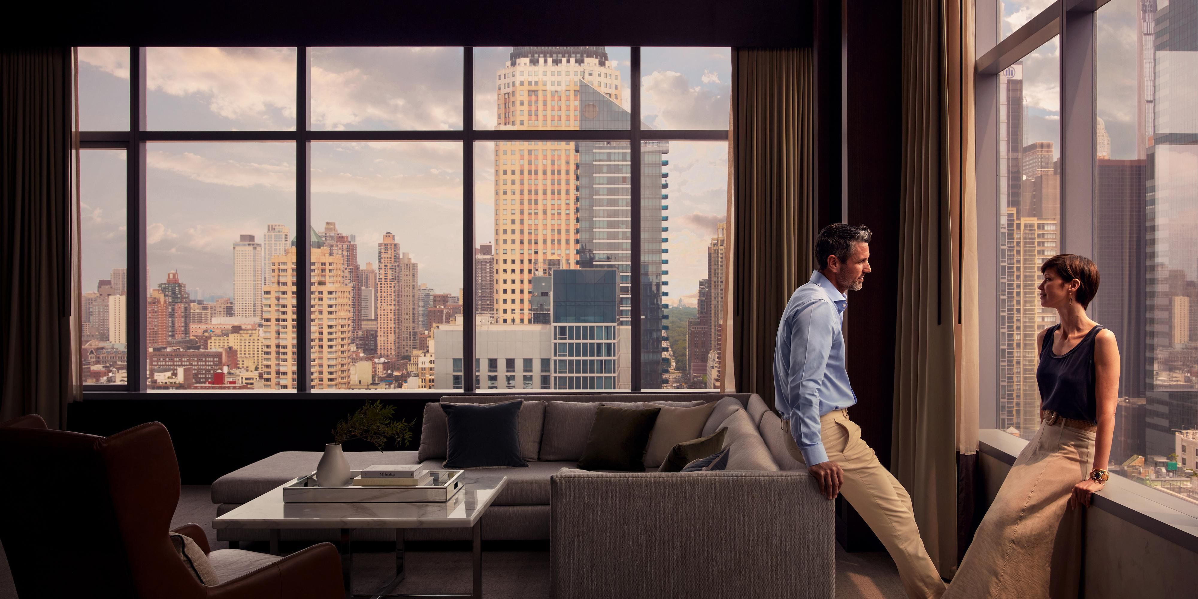 The 2,700 square feet Duplex Penthouse features a main bedroom with a fireplace and an oversized bathroom with a clawfoot tub. The bright living room is furnished with a marble dining table for eight, a pendant chandelier, a fireplace, two stories soaring windows with dramatic Times Square, Hell’s Kitchen, and Hudson River views.