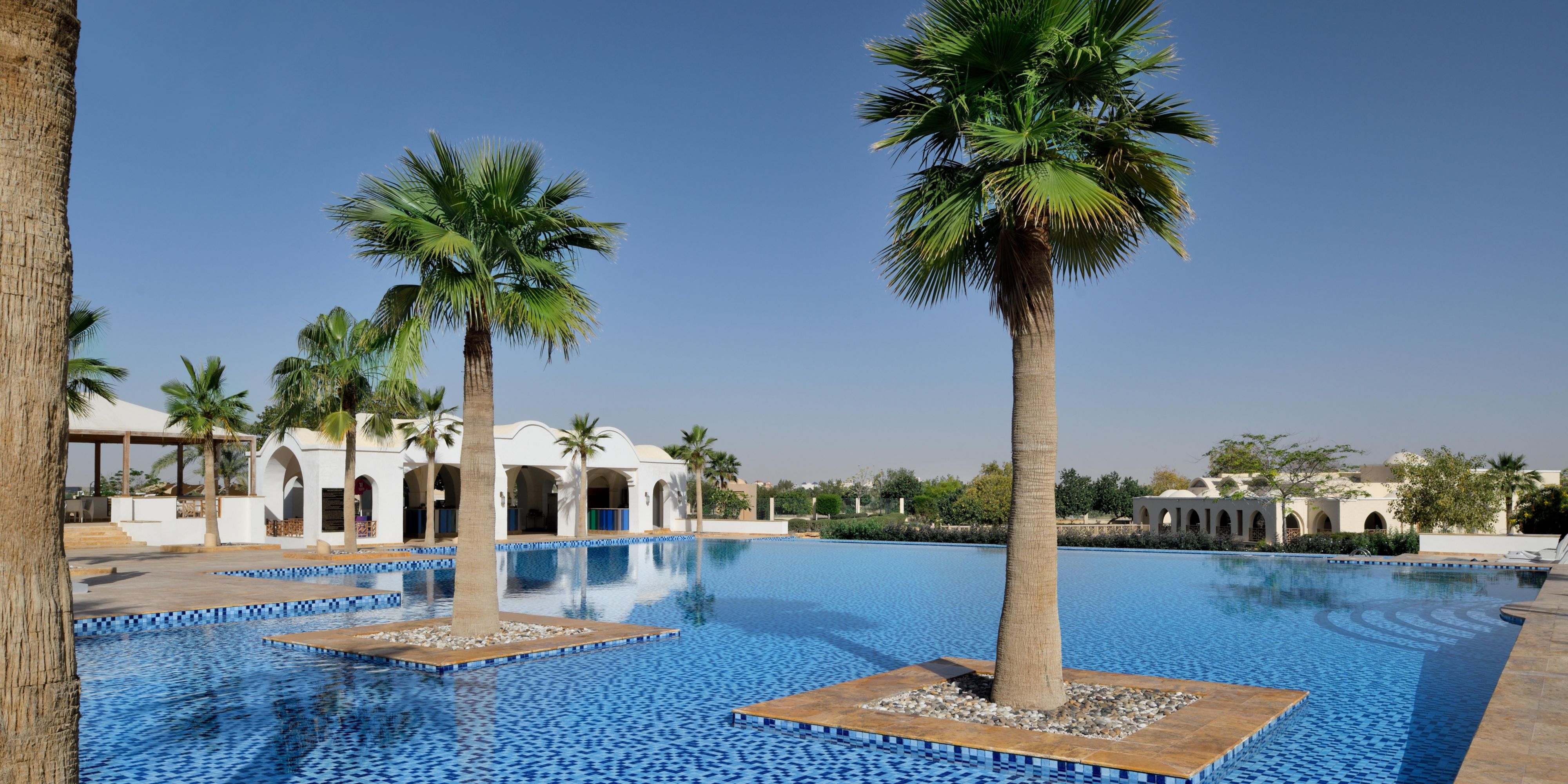 Our spacious outdoor swimming pool is a relaxation oasis with sun loungers lining its perimeter. Surrounded by our resort’s lush gardens, it’s the ultimate spot to recharge and soak up the tranquil atmosphere. Grab ice-cold beverages and delicious snacks, including our signature club sandwich, from the poolside café.